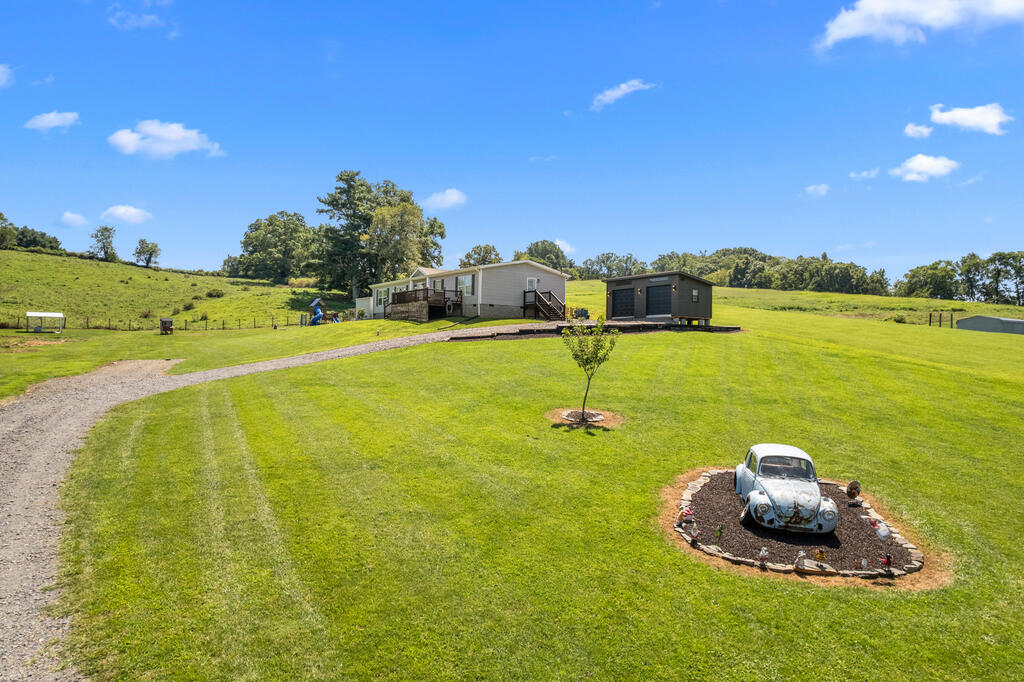 Built in 2021 and surrounded by peaceful countryside views, this inviting 3-bedroom, 2-bath home offers comfortable one-level living with a spacious open-concept design. The flexible floor plan includes an additional room perfect for a family room, home office, or hobby space, plus a large mudroom with its own kitchenette for added functionality. The primary suite features a generous walk-in closet, double vanity, and walk-in shower. Outside, enjoy open land, a stream, and beautiful rural scenery with plenty of room to enjoy the outdoors. A heat pump provides year-round comfort. Conveniently located near Hillsville and within easy reach of some of Southwest Virginia's favorite destinations, including the Blue Ridge Parkway, New River Trail State Park, Galax, the Blue Ridge Music Center, and the New River - making this a great option for those who love mountain scenery, outdoor recreation, and everything the region has to offer.