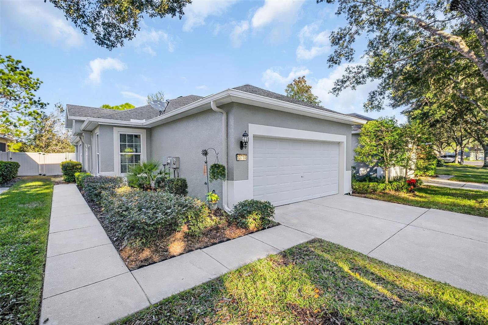 One or more photo(s) has been virtually staged. Welcome to this beautifully updated villa in the highly desirable Lakeside community, offering true maintenance-free living with the roof, exterior, and lawn care all handled by the HOA. This thoughtfully designed home features 2 bedrooms, 2 bathrooms, and a versatile office/den, with an open floor plan and split-bedroom layout ideal for privacy and everyday comfort.The recently renovated kitchen showcases granite countertops, updated sink and faucet, stylish backsplash, and new garbage disposal, opening seamlessly to the main living area. Interior updates include refreshed paint and flooring throughout (2023), Hardwood flooring in the living room, and waterproof luxury vinyl plank tile flooring in the halls and laundry room. Both bathrooms have been remodeled with granite countertops, luxury fixtures, and upgraded flooring.Enjoy year-round outdoor living and amazing views of the preserves on the large covered lanai, featuring tile flooring, screening, pull-down sun shades, and enhanced programmable seasonal lighting. A new backyard fence (2025) adds privacy and charm.Major improvements include a new heat pump with infrared lights (2024), RPG hurricane-rated windows (140 mph), Reem performance hot water tank (2023), gutters with gutter guards, new ceiling fans, and a new garage door opener (2021) and exterior of home painted in 2024. The HOA is scheduled to replace the roof in April 2026, adding even more value and peace of mind.Lakeside offers resort-style amenities, including a clubhouse, swimming pool, event room with full kitchen, basketball court, dog park, and tennis and pickleball courts. Ideally located just minutes from shopping, dining, entertainment, and top-rated medical facilities, this move-in-ready villa is the perfect blend of comfort, convenience, and carefree living.