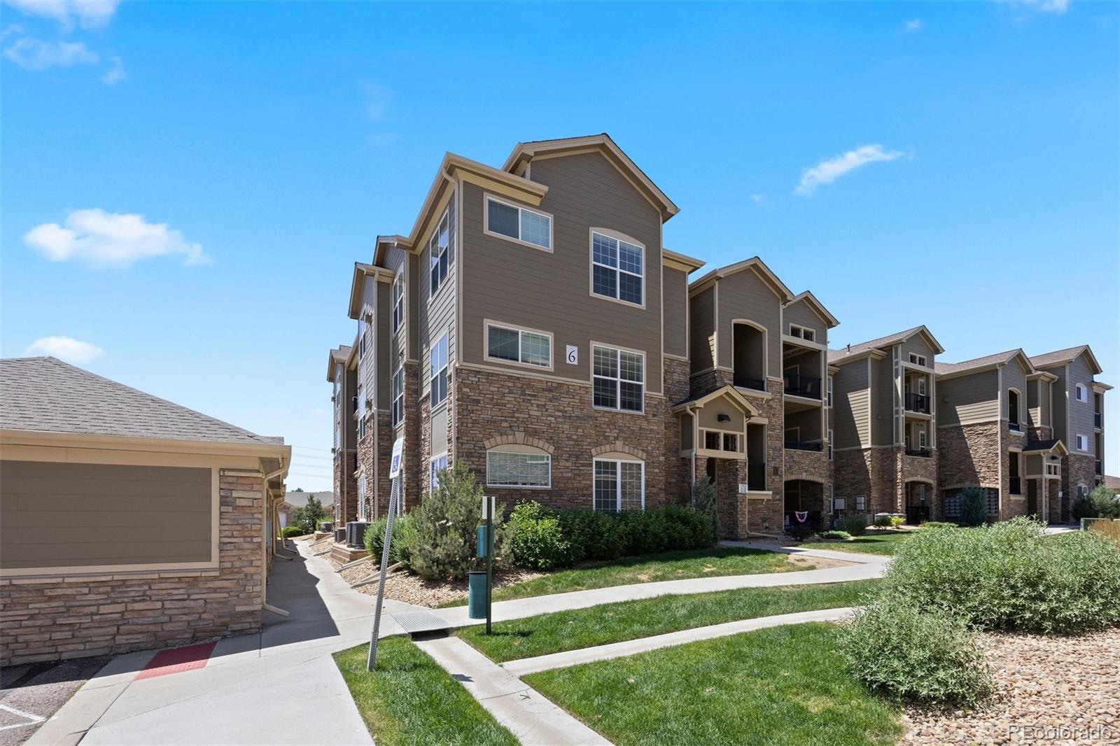 Welcome to Prairie Walk on Cherry Creek, where style, convenience, and community merge. A rare find, this three-bedroom condo makes a solid home base—ideal for those who want to come and go without the hassle.  With a sparkling community pool, playground, and gym, and convenient access to Parker Road and 470, everything you need is close at hand, 

With no neighbors above and windows on two sides, this beautifully updated corner home offers both privacy and natural light. The open layout centers around a kitchen made for connection, featuring an oversized granite island with breakfast bar seating, pendant lighting, dark wood cabinetry, and Whirlpool appliances including a range, microwave, fridge, and dishwasher. The living room invites you in with a gas fireplace and natural light streaming through oversized windows, while the adjacent dining nook—with room for 4 to 6—is beneath a modern fabric chandelier. Or step out onto the private covered balcony, offering a storage closet and room to breathe.  

The primary bedroom is a spacious retreat, with 11’ vaulted ceilings, new carpet for comfort, and a walk-in closet with organization system. The ensuite offers double sinks, granite counter tops, and a walk in-shower. Two additional bedrooms—one perfect for an office or guests—share a full bath. In-unit laundry rounds out the convenience with Whirlpool machines and built-in storage. 

Some loan limitations, ask listing agent