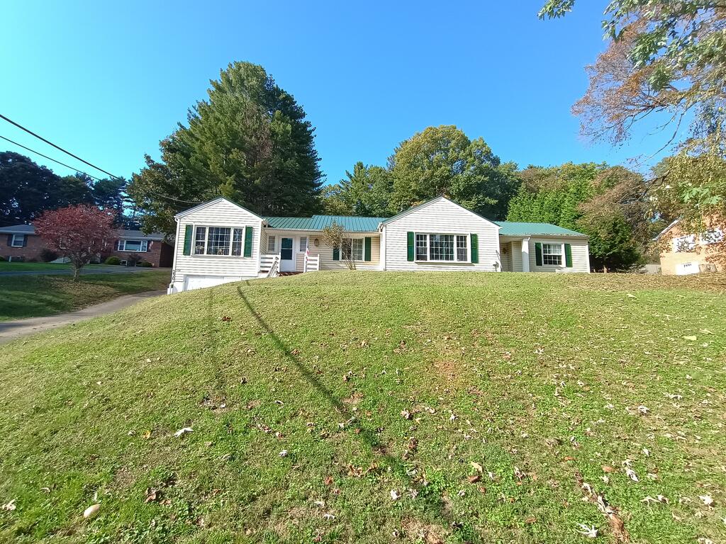 Discover the space, flexibility, and functionality this large home in Galax has to offer! The main level provides convenient one-level living, currently featuring 3 bedrooms and 2 full bathrooms. A fourth bedroom has been repurposed as a laundry and pantry area, offering excellent storage and the potential for flexible use. Laundry hookups are available on both the main level and in the basement.  Recent updates include a newer metal roof installed in Fall of 2025 and an added covered back porch, creating a great spot to relax and enjoy the outdoors. The former garage has been converted into a spacious storage room with double swinging doors but could easily be converted back into a garage to suit your needs.  The basement offers a combination of finished and unfinished space and is currently being used as an additional living area, complete with a half bath. This versatile space provides plenty of possibilities for recreation, hobbies, storage, or additional living needs.  Outside, you'll find multiple outbuildings, including a large, powered shed and a chicken coop, offering excellent options for extra storage, workspace, or enjoying a more rural lifestyle. The camper currently on the property is used for storage and may be included by negotiation. Basement appliances are also negotiable.  With generous living space, flexible room arrangements, a versatile basement, recent improvements, and useful outdoor amenities, this property offers plenty of potential and opportunity to make it your own!