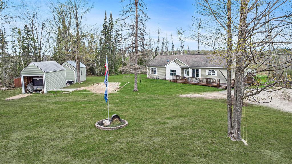 Tucked away on just over 20 acres, this updated 4-bedroom, 3-bathroom home (plus a non-conforming 5th bedroom) offers space, privacy, & room to roam. Thoughtfully updated by the current owners after purchasing it as a foreclosure, the home now features a spacious kitchen, tasteful paint selections throughout, & a generous walk-out basement with both a rec space and a cozy sitting area--perfect for relaxing or entertaining. Outdoors, three sizable sheds provide plenty of space for tools, toys, or hobbies. Nature lovers will appreciate the wildlife sightings right from the home, with deer and even the occasional bear making an appearance. Whether you're looking for peace & quiet, more space, or the ability to explore the outdoors right in your backyard, this property has it.