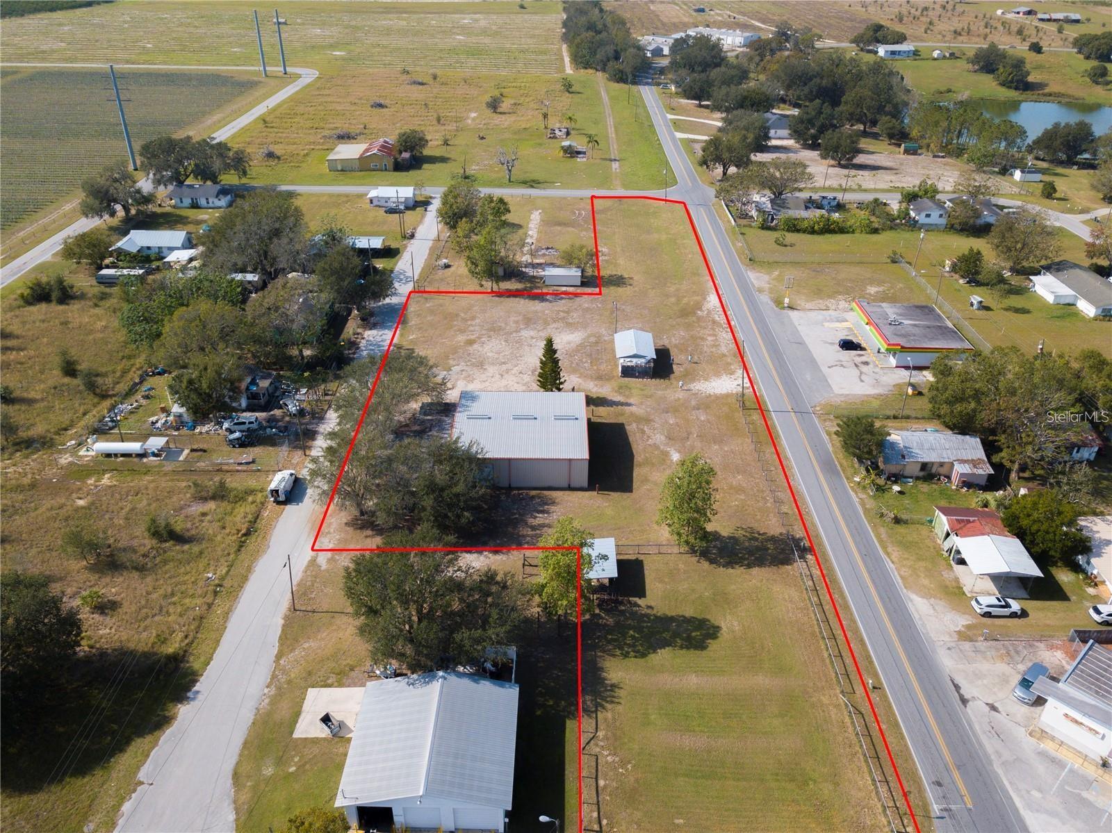 Discover the potential of this versatile 2.64 acre commercial property located in Bartow, the county seat of Polk County and centrally positioned in the heart of Florida. With two buildings, cross fencing, and multiple zoning possibilities, this property is ready to accommodate a wide range of business ventures.The main building offers a professional office setting complete with five private offices, a conference room, kitchen, and bathroom facilities, making it ideal for administrative or client-facing operations.The second building, a durable 60x40 steel structure, is currently utilized as agricultural support space for tractors, semis, and heavy equipment. Its size and functionality make it perfectly suited for a variety of commercial or industrial needs.With the property being cross-fenced, it also presents an excellent opportunity for storage solutions, including RVs, semis, boats, or other large equipment.The current owner is willing to sell, the business and the real estate or just the real estate or will consider triple net lease...Asking price is for real estate only! Owner willing to sell business for additional price.