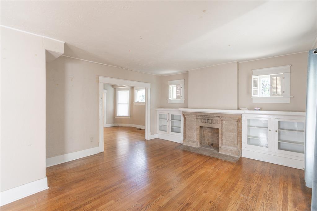 This charming 4-bedroom residence presents a prime opportunity in an exceptionally coveted and walkable location, situated just steps from the vibrant dining, entertainment, and shopping of the Uptown 23rd Street District and the historic Tower Theatre. The home retains significant character, featuring beautiful wood flooring and a central living room enhanced by built-in shelving surrounding the fireplace. A spacious kitchen provides ample cabinet storage, and the generous layout is completed by a large backyard. With strong underlying structure and period charm, this property offers an outstanding canvas for a buyer seeking to execute a personalized renovation and secure a residence in one of Oklahoma City's most dynamic urban corridors.