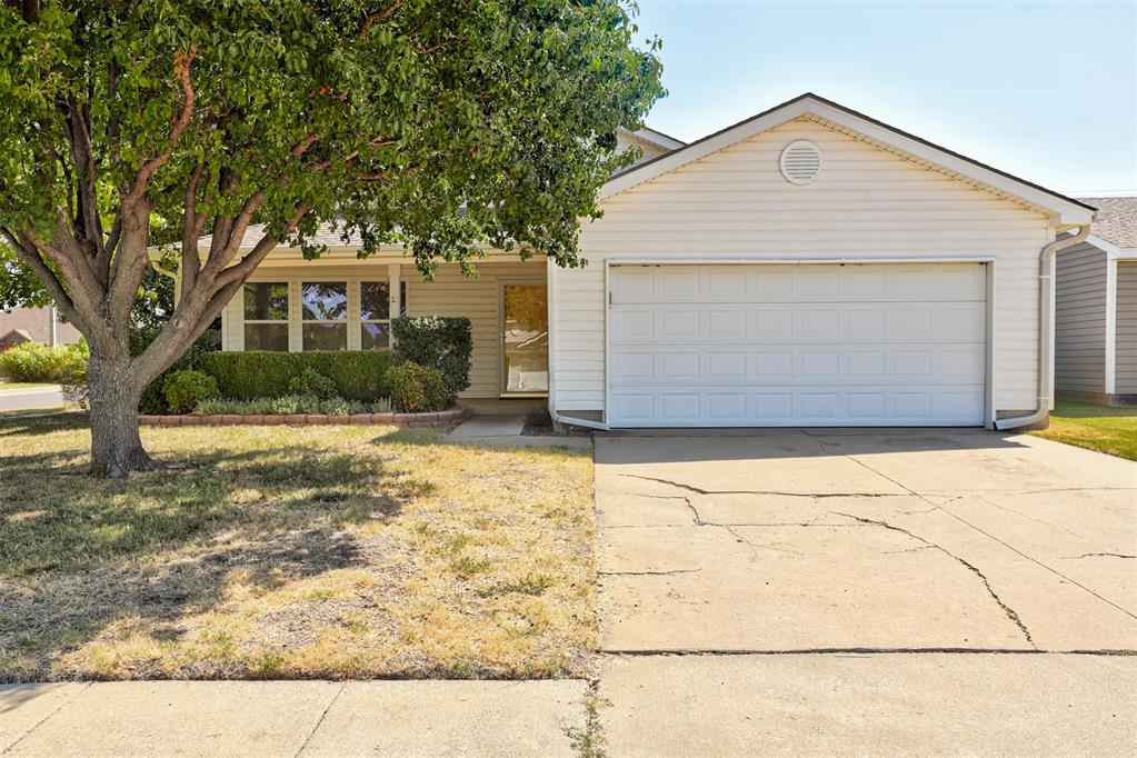 Situated on a large corner lot, this three-bedroom, two-bathroom home offers comfortable living spaces, fresh interior updates, and a spacious backyard. A large covered front porch welcomes you into the home and opens to a generous front living room with a vaulted ceiling and plenty of natural light.Brand-new vinyl flooring runs throughout the home, complemented by fresh interior paint and updated modern black door hardware. Just beyond the living room, the kitchen connects to a large dining area with plenty of room for a full-size table and views of the backyard. The refrigerator will remain with the home.The home includes three bedrooms, with the primary bedroom positioned toward the back of the house overlooking the backyard and featuring a large closet. Two full bathrooms and a two-car garage complete the interior layout.Out back, the large fenced yard provides plenty of room to relax, play, or entertain. A spacious paver patio with a wood pergola creates a great outdoor gathering area, while the full wood privacy fence offers added separation. The backyard also includes a large below-ground storm shelter. The roof is scheduled to be replaced in September 2026.With fresh updates, generous indoor and outdoor spaces, and a large corner lot, this home is ready for its next owner.