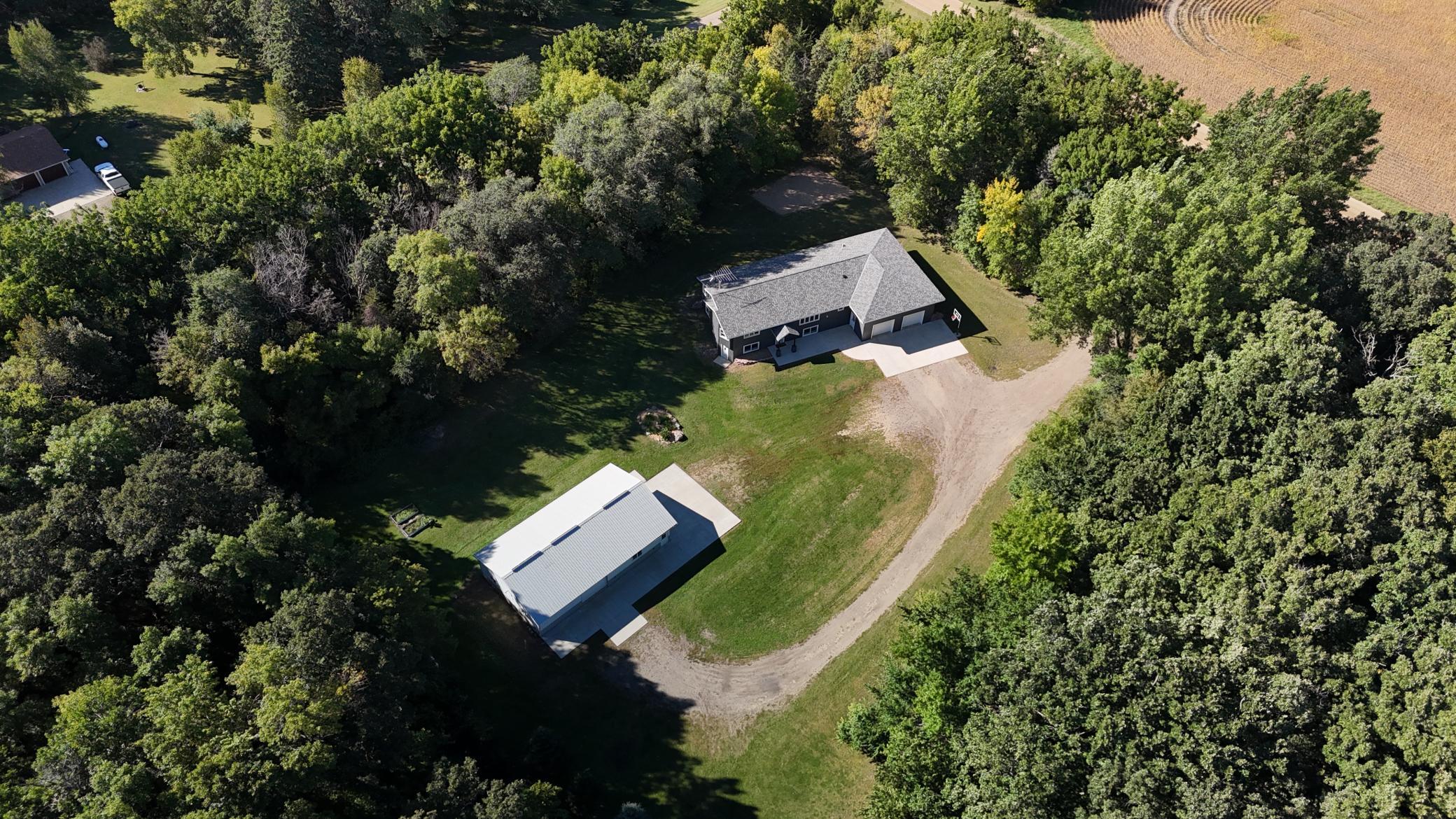 Welcome to this spacious Bass Lake property offering 3,976 finished square feet on a beautiful 3.82-acre lot with mature trees, a private setting and lake views from the home. This 5-bedroom, 2.5-bath split-level features a walkout basement, attached 2-car garage and an impressive 30x50 heated shop—perfect for extra vehicles, toys, hobbies or storage. The property also includes 10 feet of deeded access to Bass Lake, giving you the opportunity to enjoy the lake without the expense of direct lakeshore ownership. Inside, you'll find multiple living spaces with plenty of room to spread out, along with abundant storage throughout. The basement was finished in 2021 with new windows, trim and more. Additional updates include a new roof in 2019, concrete in 2017, refrigerator in 2021, washer in 2020, dryer in 2026 and new flooring throughout almost the entire upper level in 2026. Great location with space, privacy, lake access and a hard-to-find heated shop—all available for a quick close! Don't miss the virtual tour; if it isn't displayed on the website you're viewing, ask your REALTOR® to send it to you. Some rooms have been virtually staged.