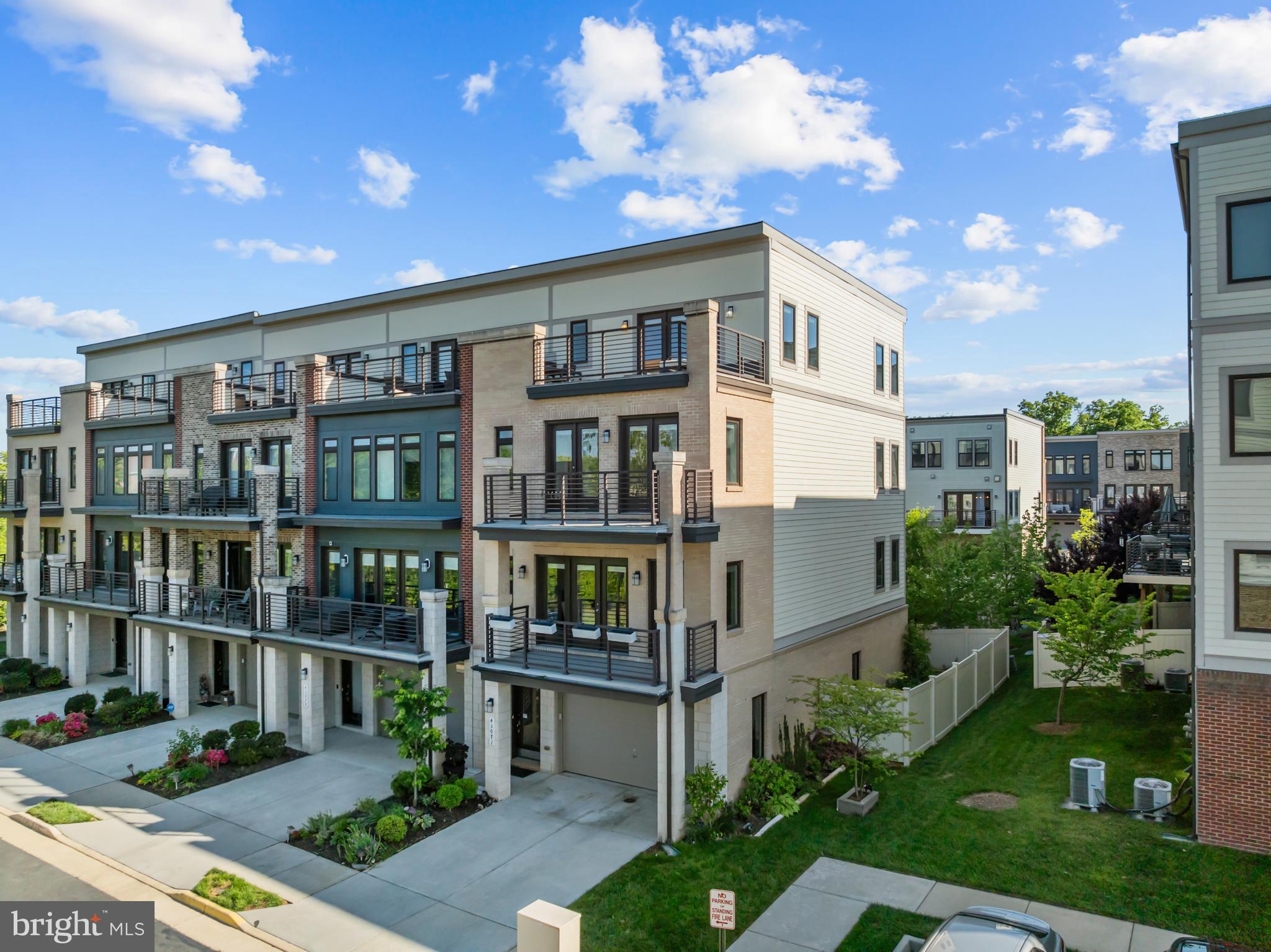 Welcome to this stunning contemporary townhome in sought-after Ashburn Overlook, where modern style, comfort, and convenience converge. This luxurious end unit 4-level townhome with a private elevator is ideally situated on a premium lot within the highly desirable Belmont Station, Trailside, and Stone Bridge High School pyramid. Designed with elegance and functionality in mind, the home features an open-concept layout filled with natural light, designer finishes, oversized windows, and multiple outdoor living spaces including an expanded deck, balcony, and rooftop terrace. The chef’s kitchen is a true centerpiece, showcasing a massive 14 foot granite island, upgraded stainless steel appliances, and ceiling height cabinetry. Additional highlights include a loft level entertaining space and a spacious lower level with dog wash station, and direct access to the fully fenced backyard complete with a patio. Ideally located near shopping, dining, One Loudoun, Lansdowne Town Center, Dulles Airport, and major commuter routes, this exceptional home offers luxury, comfort, and a low-maintenance lifestyle in a prime location.