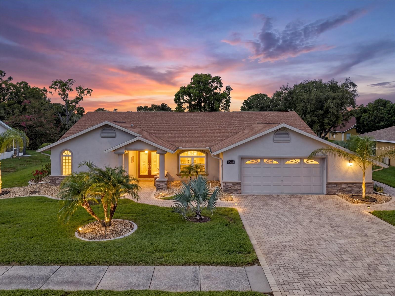 IMAGINE THE ENDLESS AMOUNTS OF FUN YOU CAN HAVE IN THIS FLORIDA POOL HOME! This 3-bedroom, 2-bath pool home sits inside the gated community of Pristine Place in Spring Hill,  2,260 square feet, move-in ready, and it shows like it's been genuinely cared for, not just cleaned up for photos. Walk in and the vaulted ceilings and skylights open the place right up. A triple glass pocket slider disappears completely, so the family room flows straight out to the enclosed lanai and the pool — which is now heated, so it's not just a summer feature anymore! The kitchen is set up to actually cook and gather in. Granite counters, stainless appliances, a tile backsplash, and a large pantry within reach. You've got a breakfast nook, a family room, and a formal dining area, so there's room for everyday life and for hosting. The primary suite has a newly tiled shower, a double vanity, and a walk-in closet. Both bedrooms have walk-in closets, and the second bedroom opens directly onto the pool and lanai — good for guests, good for multi-generational living, good for anyone who wants their own access without cutting through the house. Here's what's been done recently, and none of it's cosmetic: brand-new roof 2023, new hurricane-rated windows throughout 2022, AC Replaced 2022, fresh paint inside and out, all-new luxury vinyl flooring, and an irrigation well feeding the sprinkler system — so your water bill isn't taking the hit for a green lawn. Newly planted fruit trees - Lemon, Peach, Pomelo and Avocado! Laundry room has abundant storage and a utility sink. Location's easy just minutes to 589/Expressway and Cortez Blvd, so you're never far from anywhere you need to be. Homes like this in Pristine Place don't sit long. SCHEDULE YOUR SHOWING TODAY!