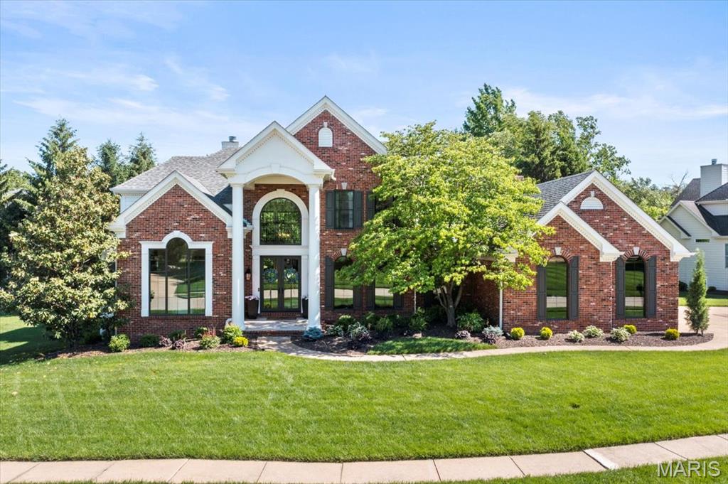 Welcome to 961 Tara Oaks Drive, an impressive 1.5-story residence situated on over half an acre in the sought-after Tara at Wildhorse community of Chesterfield. Thoughtfully designed for both everyday living and entertaining, this stately home offers an exceptional combination of generous living spaces, timeless architectural details, and resort-style outdoor amenities. From the moment you enter, the soaring two-story foyer creates an inviting first impression, complemented by beautiful hardwood flooring and elegant details throughout. A formal dining room provides the perfect setting for gatherings and special occasions, while the private study with built-in cabinetry offers a sophisticated space for working from home. At the heart of the residence, the dramatic two-story great room is anchored by a fireplace and an expansive wall of windows that fills the space with natural light while showcasing views of the backyard. The spacious eat-in kitchen is designed with entertaining in mind, featuring granite countertops, a large center island, custom cabinetry, a planning desk, and a convenient butler’s pantry. The adjoining breakfast area creates an effortless transition into the vaulted hearth room, offering another comfortable gathering space and making the main level ideal for everything from casual mornings to hosting family and friends. The main-floor primary suite provides a private retreat with a generously sized bedroom and expansive en-suite bath featuring dual vanities, a soaking tub, separate shower, and ample storage. Upstairs, a dual staircase leads to three additional spacious bedrooms and two full bathrooms, providing plenty of room for family, guests, or additional office space. The finished lower level significantly expands the home’s entertaining and recreational possibilities. Complete with a wet bar, game room, family room with fireplace, full bathroom, and flexible bonus space, this level can easily accommodate movie nights, game days, overnight guests, a home gym, or additional living space. Outside, the backyard has been designed as a private retreat. A custom covered patio provides a comfortable setting for outdoor dining and lounging, while the heated in-ground pool with a waterfall feature creates a resort-like centerpiece for summer entertaining. Professional landscaping, a dedicated fire pit area, and the expansive level yard complete the outdoor setting, offering multiple spaces to relax, gather, and enjoy the property. Additional highlights include an attached oversized garage, main-floor laundry, extensive storage, zoned heating and cooling, an irrigation system, and numerous thoughtful features throughout. Set on approximately 0.56 acres in the Rockwood School District, 961 Tara Oaks Drive offers an exceptional opportunity to enjoy spacious living, impressive entertaining spaces, and a private backyard oasis in the heart of Chesterfield.