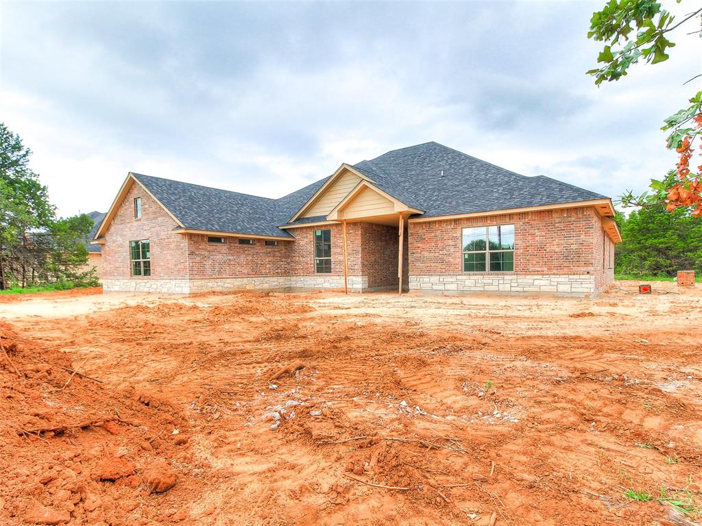 ***Seller is offering $5,000 in concessions for buyer to use towards upgrades, closing costs or even a rate buy down!* Welcome to Whispering Winds – where peaceful living meets top-tier craftsmanship! This stunning new construction is brought to you by an award-winning metro builder and is packed with all the features you've been dreaming about. With 5 spacious bedrooms, 3 full baths, and 2,747 square feet of thoughtfully designed living space, there's room for everyone to spread out and enjoy. The heart of the home is the gorgeous kitchen—complete with granite countertops, stainless steel appliances, under-mount sink, garbage disposal, and plenty of space to whip up your next culinary masterpiece. Cozy up in front of the wood-burning fireplace on chilly evenings, or enjoy the peaceful surroundings of your .75-acre lot (MOL) with a private water well and aerobic septic system. But wait—there’s more! Bring your toys, tools, or big dreams because this property includes a 4-car attached garage PLUS a 30x40 shop—perfect for hobbyists, gearheads, or anyone needing extra space to create and store. Located in Edmond’s newest gem, Whispering Winds, this home gives you the freedom of wide-open spaces with the convenience of a short drive to town. Don't miss your chance to own a slice of the good life—schedule your tour today and fall in love with your forever home!
