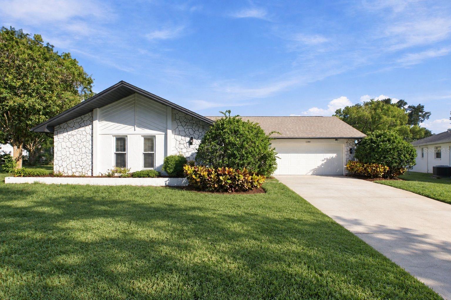 Virtually Staged. Experience the best of Florida living in this beautifully renovated and rarely available 3-bedroom, 2-bath, 2-car garage home with nearly 1,900 heated square feet, a large interior laundry room, and an oversized nearly quarter-acre lot perfectly situated on a quiet cul-de-sac just steps from the main clubhouse in Palm Harbor’s premier 55+ golf community, Highland Lakes! Everything is NEW, NEW, NEW! From the moment you step inside, you’ll be greeted by stunning new flooring flowing seamlessly throughout the home, fresh paint and baseboards, all-new fans, fixtures and hardware, new recessed lighting, zero popcorn ceilings, a skylight in the main living area, large updated windows, and beautiful views throughout the newly opened floor plan. The remodeled and opened kitchen is a true showstopper, featuring floor-to-ceiling solid wood cabinetry, gorgeous quartz countertops, a cozy breakfast nook for casual dining, and all-new sleek stainless-steel appliances. The oversized primary suite offers plenty of room for a king-size bedroom set plus additional space perfect for a home office or cozy sitting area, along with a massive walk-in closet and fully renovated en-suite bath featuring a new stone-top vanity, mirror, lighting, and glass-enclosed walk-in shower. Two additional spacious bedrooms provide comfortable accommodations for guests and endless flexibility for an office, craft room, or additional living space. The large Florida room provides even more space for relaxing or entertaining and opens to an additional fully enclosed bonus lanai that is not included in the home’s heated/cooled square footage. Major improvements include a new A/C system (2026), updated electrical panel (2023), new roof (2022), and new water heater (2025). The home is also ideally situated high and dry in a NON-FLOOD ZONE and NON-EVACUATION ZONE! Highland Lakes offers an incredible lifestyle with a low HOA fee that includes unlimited FREE GOLF on three private executive courses, tennis, pickleball, bocce, shuffleboard, an active clubhouse with countless clubs, activities and fitness classes, plus exclusive access to the Lake Tarpon Lodge featuring a private boat ramp, fishing pier and pontoon boats. Residents also enjoy complimentary RV and boat storage and golf-cart-friendly streets. Just minutes from award-winning Gulf beaches, restaurants, shopping, healthcare, major airports and the Port of Tampa, this exceptional home offers the perfect combination of location, amenities and the Florida lifestyle you’ve been dreaming of. Better than new construction and completely turnkey—just bring your belongings and enjoy! Schedule your private showing today!