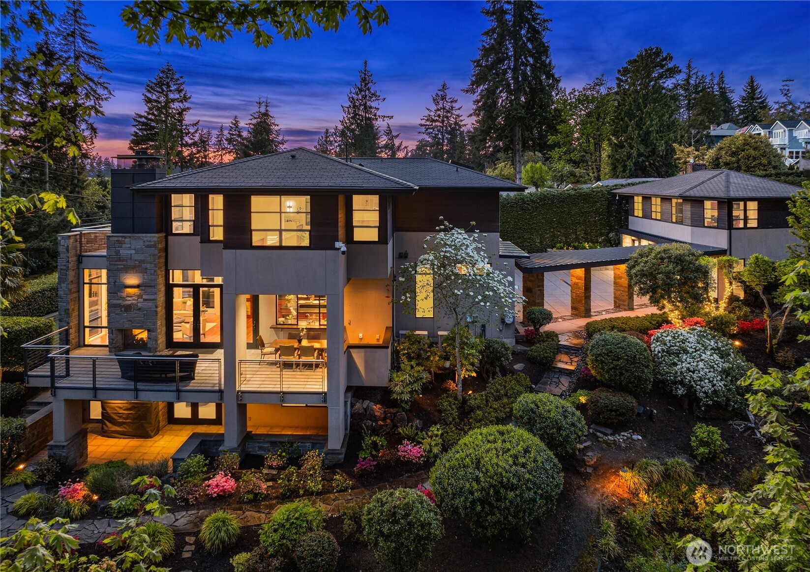 Experience unmatched luxury & global sophistication in West Bellevue—an architectural masterpiece by Bender Custom Homes. Nestled on over three-quarters of an acre, this modern estate features clean lines & premium materials such as metal, bluestone, cherry, & mahogany. Towering floor-to-ceiling windows frame stunning western sunsets, while the covered outdoor living area invites year-round enjoyment & entertaining. Thoughtfully designed for comfort & leisure, the property includes a lush private garden, 4 hole putting green & a detached guest house for added flexibility. Located in one of Bellevue’s most coveted neighborhoods, it offers seamless access to world-class dining, shopping, & amenities.