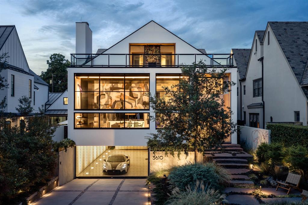 3610 Lindenwood Avenue is one of the few homes that can claim Lockhart Park as an extension of its own grounds. Facing the greenspace, it rises as a modern residence built to commercial standards — and composed around light & texture. Architect James Langford conceived the home in 2016 and returned alongside acclaimed contractor Susan Newell, to lead its extensive 2023-2025 renovation. The result is a house that engages all the senses, from the entry to the pool's edge. On the main level, the great room soars twenty-two feet to a wide band of clerestory windows, anchored by a cold-rolled steel centerpiece that seamlessly integrates the fireplace, television, and surround sound into a single plane. The Bulthaup kitchen centers on two islands — one clad in four level-7 bookmatched & illuminated onyx slabs — and features Sub-Zero, Miele, and dual Thermador appliances. At the back, a lounge with a full bar opens to a covered porch with an outdoor kitchen and motorized screens. The new spa & pool are connected by a waterfall and set among fire & water features, landscape lighting and a stretch of lawn. Privacy walls and magnolias wrap the yard, lending it the intimacy of a private resort. The uppermost story is given entirely to the roughly 1,400-square-foot primary suite, with direct elevator access, his & hers bathrooms, a coffee bar, an electric fireplace, and an en-suite screened-in porch leading to a private terrace with the park spread below. Three large bedrooms, a library, and a kitchenette occupy the second floor, while the ground level holds a four-car garage, workshop, gym, and prep pantry. Built on a steel frame with post-tensioned concrete throughout, the residence is served by an elevator to every story, a whole-house generator, Lutron and Sonos controls, lightning defense and leak protection. Zoned to Armstrong Elementary in HPISD, this coveted address is two blocks from the Katy Trail, Y’all Street on Knox, and a pleasant walk to Highland Park Village.