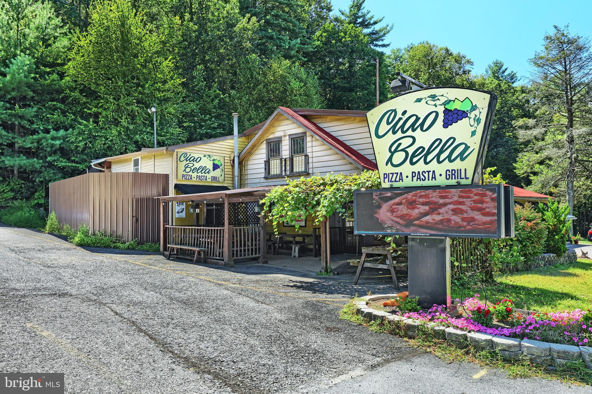 Extraordinary opportunity for an up-and-coming restauranteur!   Sale includes restaurant equipment and the Real Estate.    This restaurant is turn-key and let's go.   Sparkling clean equipment, kitchen, hood system,  pizza oven, and dining room.   Walk-in freezer and refrigerators with surge protectors, and self-close doors.  Separate dish room, separate office, and open design bar area where customers can see the Chef in action. Restaurant has ample parking, great visibility, easy access, and bright signage.   Also note the property sits on 4.15 wooded acres that backs up to State Game Land.    2nd floor includes a storage room and a nearly complete 1 bedroom apartment for additional income.  Unique and entrepreneur ready.