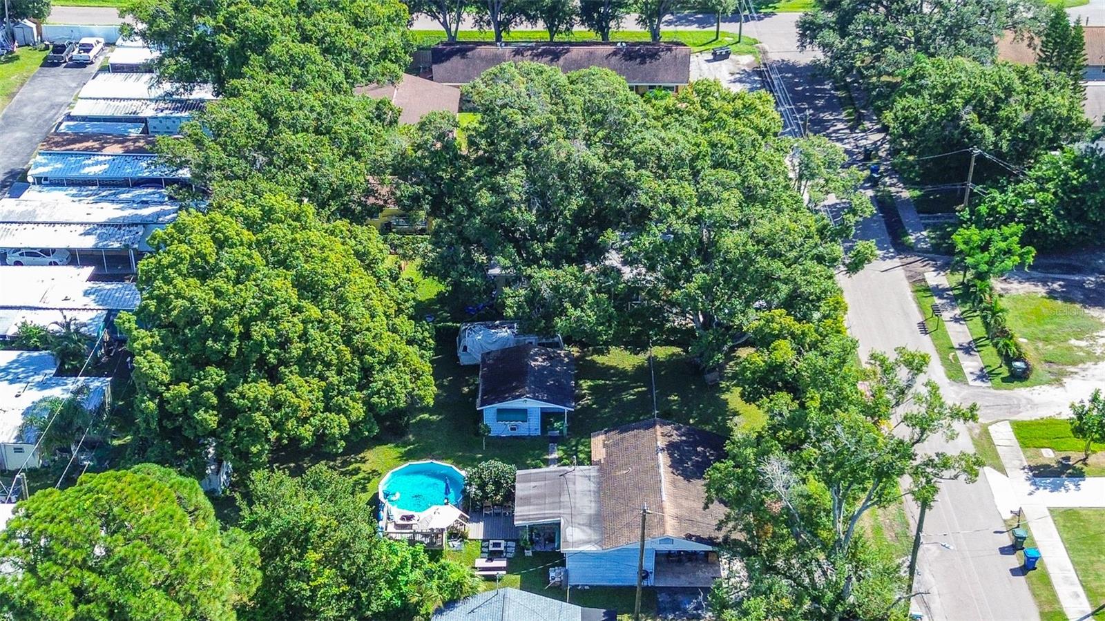 ONE OF A KIND PROPERTY! TWO BUILDINGS ON TWO LOTS (105x150ft) – You Can Separate or Keep Combined! TWO DWELLING UNITS – 1st BUILDING/MAIN HOUSE 3BR/1BA/919sqft. 2nd BUILDING – 1BR/252sqft. TUFF SHED w/ electric and plumbing 144sqft. *20ft ABOVE GROUND POOL* w/ DECK. Plus a Storage Shed. SO MANY FEATURES! Oversized 105x150 lot gives you plenty of room for multiple vehicles, boats, campers, trailers. FULLY FENCED for your pets to roam. Sits on .36 acres of land can be subdivided into two separate dwellings. NO HOA, NO CDD, NO FLOOD ZONE. The thoughtful arrangement is PERFECT FOR MULTI-GENERATIONAL LIVING offering a PRIVATE SETUP that works beautifully as an IN-LAW SUITE or a dedicated RETREAT FOR A TEEN OR TWENTY-SOMETHING. This design provides distinct, comfortable spaces for both hosting extended family and ensuring daily privacy.4 bedrooms, 1 bathroom, 1 carport with 1171sqft living total. PLUS FRAMED IN AREA already plumbed FOR A 2nd BATHROOM. This is an incredible OPPORTUNITY TO CUSTOMIZE A PROPERTY and make it truly your own while enjoying plenty of built-in potential. This MAIN HOME provides the perfect canvas to add your own personal style and touches. The open kitchen with comfortable size eat-in space overlooks the spacious living room. All bedrooms are generous in size with plenty of closet space. Plus a convenient INSIDE UTILITY ROOM. Neutral color tile throughout. Endless possibilities! Excellent location! In up and coming Horizon West Bay Down-town corridor, makes it a must-see for savvy buyers ready to act fast. in an area with many attractions including; walkability, convenience and entertainment. **In addition- THE FINANCIAL GAME CHANGER: Private Income Suite Potential - The true brilliance of this property lies in the ultra-versatile potential mother-in-law or rental Suite in featuring its own private entrance and FRAMED FOR dedicated full bath, this space offers immediate flexibility: Income Generator: Rent it out to substantially offset your mortgage, turning your residence into a high-performing asset. Multi-Generational Living: A private, comfortable Mother-in-Law suite. Perfect Guest or 3rd Bedroom Suite (with existing third bedroom usage). Quiet location on a well kept street. You'll be within walking distance of newly revitalized downtown Largo with tons of activities and shops, and just 3 miles to the WORLD FAMOUS BEACHES of Pinellas County! Close to public transportation, shopping, dining, Largo Central Park. One block away to city park with fishing pond and playground. This is the move-in-ready, possible income-generating home you've been waiting for.