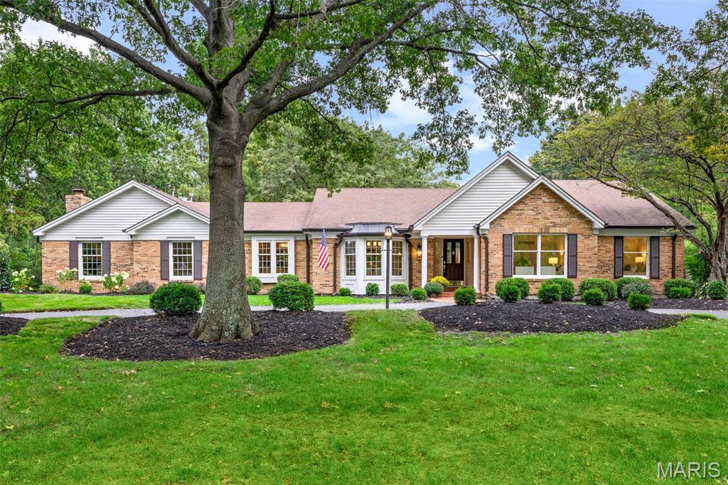 Welcome to 254 Pennington Lane, a sprawling ranch in Forest Hills Club Estates where beautiful spaces, thoughtful details and an exceptional floor plan make this a home meant to be enjoyed. From the moment you step inside, natural light fills the gracious living and dining rooms, where wood floors, crown molding and beautiful windows create an elegant yet comfortable setting for everything from holiday dinners to evenings with friends. The kitchen is equally inviting, with custom cabinetry, quartz countertops, a Viking gas range and Thermador wall ovens, while the generous breakfast room offers plenty of space to gather around the table and linger long after the meal is over. The heart of the home is a series of living spaces that each offer something a little different. The family room is warm and welcoming, with a beautiful coffered ceiling, wood-burning fireplace and French doors opening to the patio. Just beyond, the sunken den feels intimate and relaxed, with another wood-burning fireplace, custom built-ins and a wet bar complete with a Scotsman ice maker and beverage refrigerator. Whether entertaining a crowd or settling in for a quiet night at home, there is a place here for every kind of moment. The primary suite is a retreat all its own, with generous proportions, a gas fireplace and room for a comfortable sitting area. An oversized walk-in closet provides exceptional storage and direct access to the patio, while the private bath features dual vanities, a soaking tub and separate walk-in shower. Three additional bedrooms with new carpet and a full hall bath complete the sleeping wing. A spacious laundry room with custom cabinetry and an oversized three-car, side-entry garage add even more to a main level designed to make everyday living easy. Downstairs, the finished lower level gives everyone room to spread out. The expansive recreation room is ready for movie nights, game days and celebrations, with custom cabinetry, a sink and dishwasher making it easy to entertain. A separate bonus room behind French doors, another full bath and abundant storage complete the space. And then there’s the backyard—the true showstopper. A beautiful brick-paver patio and courtyard create an outdoor living space you’ll want to use every chance you get, with a tiered fountain, and plenty of room for dinner under the stars, cocktails with friends or a quiet morning coffee. From there, the backyard opens to an incredible lawn framed by mature trees and lush landscaping. There is room to run, play, host a crowd or simply enjoy the peaceful setting, all with a sense of privacy that makes it feel like your own retreat. The location brings it all together. Set within the Rockwood School District, the home is just minutes from popular shopping, dining, parks and everything West County has to offer. Forest Hills Country Club is right in the neighborhood, with membership opportunities for golf, swimming, tennis, dining and a full calendar of social activities.Offering incredible outdoor space, room to live and entertain, and a location that offers a lifestyle all its own, this is a home you won’t want to miss.