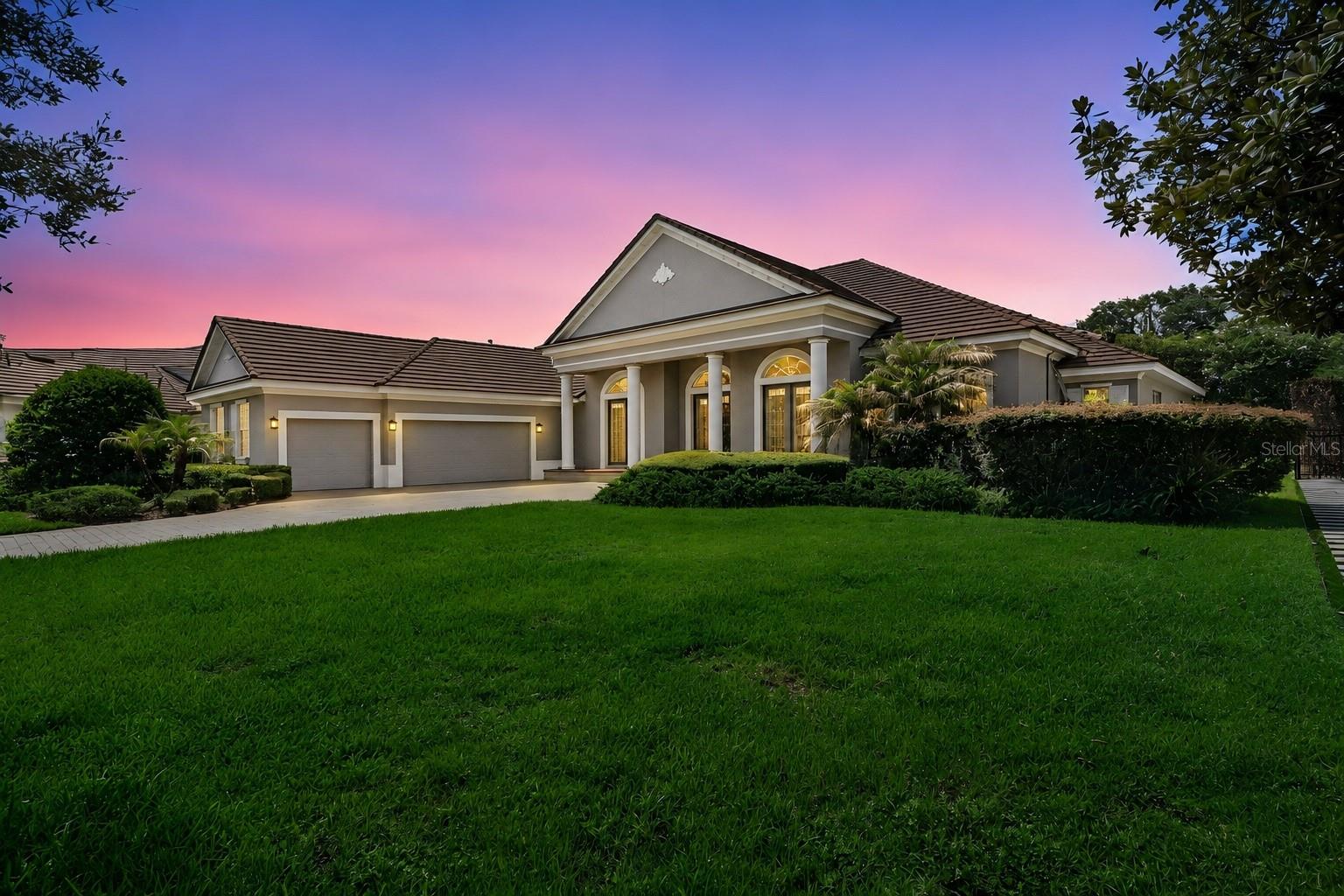 Welcome to The Reserve at Lake Butler Sound, one of Windermere's most prestigious 24-hour guard-gated luxury communities, where estate homes, tree-lined streets, and access to the renowned Butler Chain of Lakes create an unmatched lifestyle. Perfectly positioned on over half an acre at the end of a quiet cul-de-sac, this impeccably maintained 5-bedroom, 3.5-bath residence offers more than 3,750 square feet of thoughtfully designed single-story living with timeless architecture and sophisticated modern finishes.A paver driveway, mature tropical landscaping, and stately columns create an unforgettable first impression. Inside, grand beveled-glass French doors open to soaring ceilings, elegant architectural details, and expansive sightlines that lead directly to the screened pool and spa  with a beautiful ceramic tiled deck, creating a seamless connection between indoor and outdoor living.Designed for both everyday comfort and elegant entertaining, the executive open-concept floor plan features formal living and dining spaces accented by tray ceilings, custom lighting, and graceful archways. Rich wood flooring, abundant natural light, and refined finishes elevate every room.At the heart of the home, the chef's kitchen is as functional as it is beautiful, featuring granite countertops, generous prep space, a large breakfast bar, natural gas counter top and a bright breakfast nook overlooking the outdoor pool and living area. The kitchen flows seamlessly into the spacious family room, where a cozy natural gas fireplace creates the perfect gathering space for family and guests.Privately tucked away, the owner's suite serves as a luxurious retreat with travertine flooring, dual custom walk-in closets, and a spa-inspired bath complete with dual vanities, an oversized walk-in shower with dual shower heads, and a convenient wet bar. An adjoining flex space offers endless possibilities as a private office, fitness room, reading lounge, or nursery.The secondary bedrooms are thoughtfully positioned for privacy and functionality, featuring a Jack-and-Jill bathroom, an additional full bath, and spacious accommodations for family or guests. A dedicated office at the front of the home functions as a fifth bedroom, providing exceptional flexibility for today's lifestyle.Step outside to your private backyard oasis, where the screened pool and spa are surrounded by lush landscaping, ambient lighting, and an expansive covered lanai—perfect for entertaining year-round or enjoying peaceful Florida evenings.Living in Lake Butler Sound means more than owning an exceptional home—it's embracing one of Central Florida's most coveted luxury lifestyles. Residents enjoy 24-hour guarded security, a private community fishing pier on Lake Butler, beautifully maintained parks and green spaces, and proximity to the Butler Chain of Lakes, one of Florida's most desirable chains for boating, skiing, paddleboarding, and waterfront recreation. The community is also zoned for top-rated schools and is just minutes from downtown Windermere, Restaurant Row, world-class golf, major highways, Orlando's premier attractions, and an exceptional collection of luxury shopping and dining.This is a rare opportunity to own an elegant estate in one of Windermere's most sought-after luxury communities, where privacy, location, and lifestyle come together in perfect harmony.