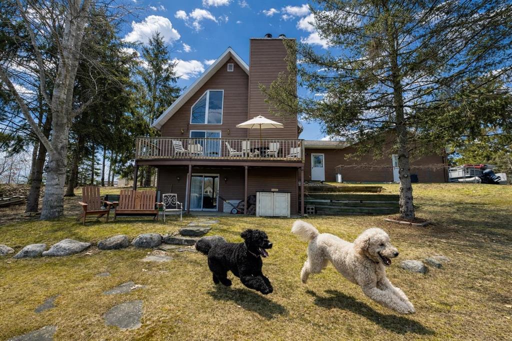 Experience the ultimate Michigan lakefront lifestyle on the stunning 700-acre, all-sports Lake Isabella in Isabella County. This charming chalet-style home offers everything you need for year-round living or the perfect Up North retreat, all accessible via a paved road for easy, hassle-free access in every season. Lake Isabella is a private lake community featuring beautiful parks and convenient boat launches, giving you and your guests everything needed to enjoy the water from day one. And for those who love to hit the links, the renowned Pines Golf Course is just minutes away across the lake. The level lot gently slopes to the water's edge, where a steel seawall protects your shoreline investment. Spend your days boating, fishing, and enjoying all the lake has to offer, then unwind on the expansive lakeside deck soaking in breathtaking water views. Inside, the vaulted living and dining room creates an open, airy atmosphere anchored by one of two cozy wood-burning fireplaces, perfect for those crisp Michigan evenings. The main floor offers two comfortable bedrooms and a full bath, while the private primary bedroom suite on the second level treats you to spectacular lake views from both the north and south. The walk-out basement connects the family room complete with the second wood-burning fireplace and direct access to a lakeside patio, seamlessly blending indoor and outdoor living. With 3 bathrooms total, there's plenty of room for family and guests. Additional highlights include a 2-car garage, high-speed internet, natural gas utilities, and a completed CMDHD TOT, making this property ready for a quick sale.