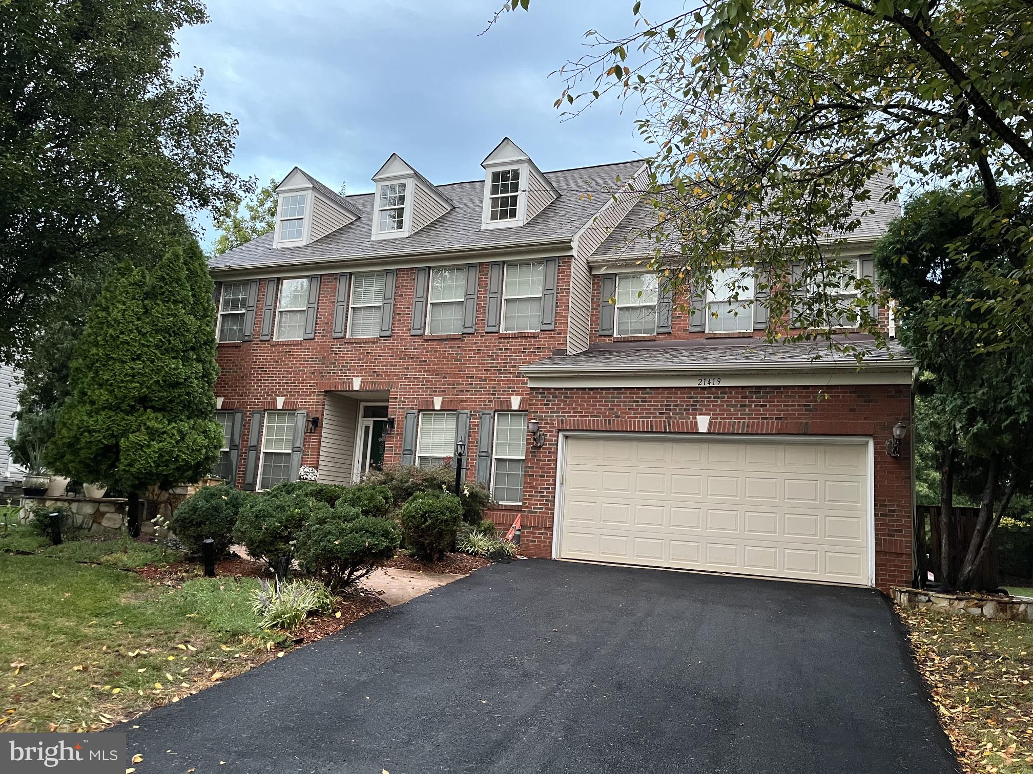 Absolutely stunning and beautifully maintained 4,260+ sq ft finished Colonial home with an additional 190+ sq ft of unfinished storage space, ideally situated with a peaceful wooded backdrop. This exceptional home is loaded with major updates, thoughtful upgrades, and spacious opened style living areas designed for both everyday living and entertaining. A newly paved driveway completed in August 2026 welcomes you to this impressive brick-front home featuring an upgraded elevation, extended library, enlarged bedroom and family room, and a spacious open floor plan. Step inside to 9-foot ceilings on the main level, crown molding, a private study/home office, second-floor laundry, and a luxurious super bath. The gourmet kitchen has been thoughtfully expanded by two feet to provide additional living space and features upgraded maple cabinetry, recessed lighting, newer stainless-steel appliances, a double wall oven, and a large island with downdraft cooktop—perfect for preparing meals while entertaining family and guests.The elegant formal dining room showcases crown molding, medallion molding, and chair rail detailing. The breakfast area opens directly to an impressive 440+ sq ft Trex deck, offering beautiful views of the tree line and an ideal setting for outdoor dining and relaxation.The spacious family room is the heart of the home, featuring a dramatic two-story ceiling, warm two-story stoned fireplace, and wall of windows that fills the space with abundant natural lighting.Upstairs, the spacious master suite features vaulted ceilings, a large walk-in closet, and dedicated his-and-her space. The renovated primary bathroom offers a double vanity, walk-in shower, and relaxing soaking tub. Three additional generously sized bedrooms, each with walk-in closets, provide plenty of space for family, guests, or flexible living arrangements.The finished lower level offers carpeted recreation room, extra wide walk-up stairs to the backyard, and a versatile multipurpose room with walk-in closet which could be used as nonconforming extra bedroom. Additional features include a ceiling fan, recessed lighting, an large upgraded bathroom, and 190+ sq ft of unfinished storage space.Outdoor recreation and community amenities are equally impressive, with residents enjoying miles of walking trails, tot lots, a volleyball court, and a multi-purpose court.Conveniently located just minutes from the Ashburn Silver Line Metro Station, with walking access to Loudoun County Transit and nearby commuter lots. Washington Dulles International Airport is less than 6 miles away, while One Loudoun, Tysons Corner, Reston Town Center, and Leesburg Outlet Mall are all easily accessible.This exceptional home combines generous living space, extensive upgrades, beautiful wooded surroundings, and convenient access to transportation, shopping, dining, and recreation—a truly remarkable opportunity.