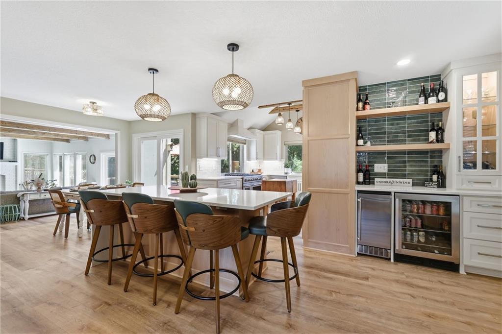 Welcome to this showstopper in Lakewood! This one has everything you've been dreaming of. The exterior features a newer roof and new windows. Step inside to discover the incredible upgrades including modern paint colors, new LVP flooring, and glass French doors to the convenient office, which would also make a beautiful formal dining room. The newly-updated kitchen is an absolute masterpiece - gorgeous finishes, chef's appliances, large island and a beverage center with ice maker and beverage fridge. Upstairs you will find four generously-sized bedrooms and two full baths. The finished, walkout basement offers an expansive 2nd living area, bathroom, and storage space. Outside, enjoy the large backyard that backs to trees and a deck that is perfect for entertaining or relaxing. All located in the acclaimed Blue Springs School District. This exceptional home includes access to Lakewood's many sought-after amenities: lake, pools, golf, tennis and more. More than a home, it's a lifestyle!