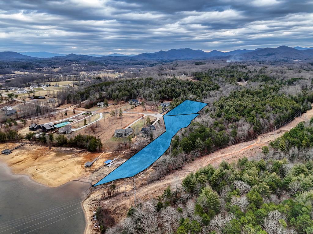 A TRULY SPECIAL LAKEFRONT PROPERTY! Build your dream LAKEFRONT escape on this 4.72 acre, two lot offering in the gated subdivision of Hidden Harbor.  Bordering the U.S. FOREST SERVICE  ensuring privacy and breathtaking views for years to come. The property features a beautiful NATURAL WATERFALL, adding charm and serenity to an already remarkable setting. Enjoy lake access with the option to install your own dock, making lake living effortless and enjoyable. An ideal canvas for a custom mountain-lake getaway surrounded by nature. Conveniently located just minutes from local restaurants, golf courses, and the hospital, offering the perfect balance of privacy and everyday accessibility.