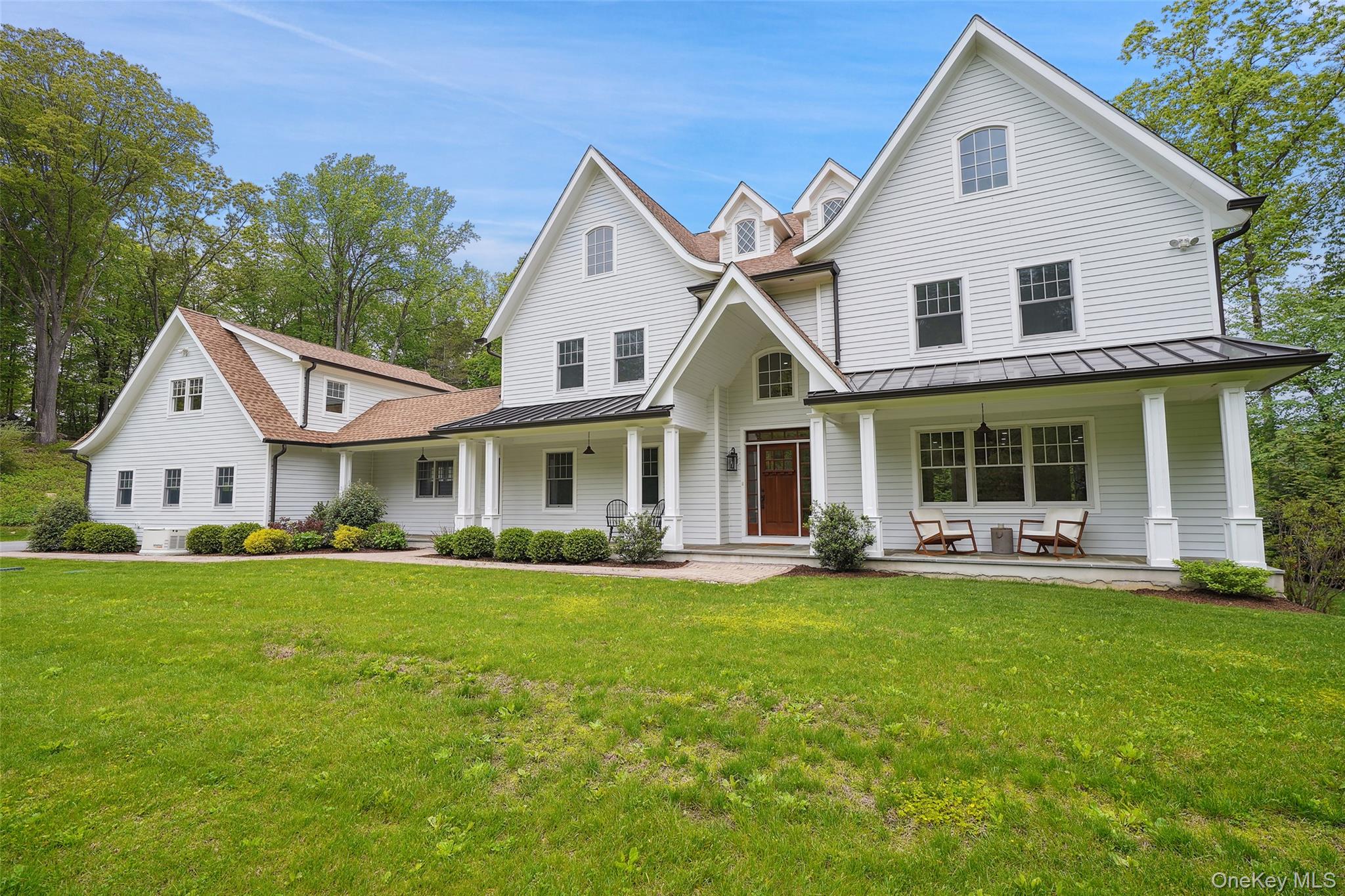 This modern 4BR Colonial reimagines classic country living with an effortless work/lifebalance. Privately sited with easy access to shopping, dining, culture and transportation inboth Connecticut and New York, the 3.48-acre property includes a personal trailhead to 7+miles of maintained hiking paths on 370 adjacent Westchester Land Trust and Leon LevyPreserve acres! Bluestone Lane is a private road including six recently completed homeswhere neighbors enjoy an HOA that manages road maintenance, plowing, and commonlandscaping. From the welcoming front porch, step inside a striking two-story entry. An open floor plan unfolds to reveal light-filled dining and family rooms with connecting bar/butler’s pantry. The spectacular, sun-drenched eat-in kitchen easily accommodates two cooks and features doors opening directly to the stone patio for effortless indoor-outdoor living. Aconvenient mudroom, laundry room, powder room and home office/library are thoughtfullytucked in on the first floor, as well. Upstairs, you’ll find a primary suite boasting a sumptuous bath. Three family bedrooms, two accompanying baths and an additional laundry area complete the second floor. Flex spaces for recreation, exercise and/or work include the expansive bonus room locatedabove the three-car garage and the large finished, walk-out basement that boasts highceilings and a full bath. Extra amenities for easy living include a whole house generator,electric car charger, abundant storage—including an unfinished full-height/walk -up attic,and priceless tranquil views from the front porch.