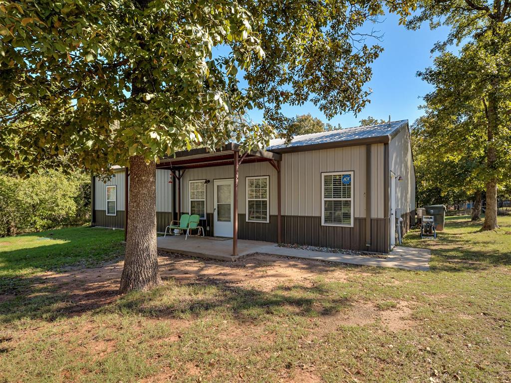 WELCOME TO YOUR PRIVATE COUNTRY RETREAT. THIS SPACIOUS  2000 SQ FT BARNDOMINIUM, SITS ON 7.9 PEACEFUL ACRES, FEATURING 4 BEDROOMS AND 2 FULL BATHROOMS. ENJOY QUIET MORNINGS, THE BEAUTY OF YOUR OWN POND,  EVENINGS BY A COZY FIRE PIT, AND A SCENIC CREEK WITH A CHARMING BRIDGE. THE PROPERTY ALSO INCLUDES A COVERED SHOP AREA WITH SPACE TO PARK ONE VEHICLE. NATURE LOVERS WILL APPRECIATE THE VARIETY OF TREES, INCLUDING PERSIMMON, PECAN, BLACK WALNUT, AND OAK, ALONG WITH MOREL MUSHROOMS GROWING NATURALLY ON THE PROPERTY. INSIDE, YOU’LL FIND NEW WOOD FLOORING THROUGHOUT, OVERSIZED PANTRY IN KITCHEN, A LARGE WALK-IN CLOSET IN THE MASTER BEDROOM AND HOME HAS A NEW HOT WATER HEATER. WITH PLENTY OF ROOM FOR ANIMALS, HOBBIES, OR GARDENING, THIS PROPERTY OFFERS PRIVACY, VERSATILITY, AND THE PEACEFUL COUNTRY LIFESTYLE YOU’VE BEEN LOOKING FOR. WE HAVE ALSO ATTACHED A FEW PHOTOS SHOWCASING THE BEAUTIFUL NATURAL FEATURES AND SCENERY THROUGHOUT THE PROPERTY, SO THAT YOU CAN GET A CLOSER LOOK AT ALL THAT THIS UNIQUE PROPERTY HAS TO OFFER.  THE ABOVE-GROUND STORM SHELTER COMFORTABLY  ACCOMMODATES 8–10 PEOPLE. ENJOY THE CONVENIENCE OF BEING JUST 8 MINUTES FROM LAKE THUNDERBIRD! THIS PROPERTY IS A MUST-SEE AND WON’T LAST LONG. SCHEDULE YOUR PRIVATE SHOWING TODAY BEFORE IT’S GONE!