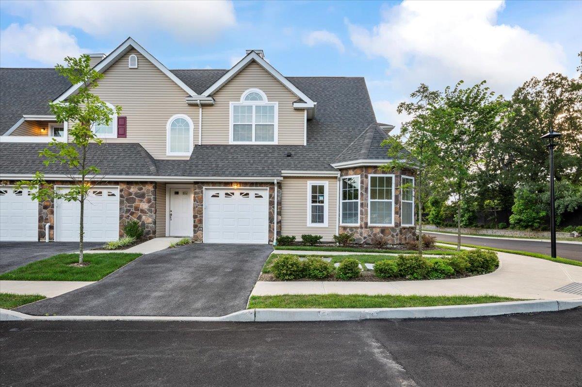 Welcome to the Essex model at Stone Ridge Estates, a 55+ gated community in Dix Hills. This brand new, just built highly sought-after end-unit boasts two bedrooms and two-and-a-half baths, offering an inviting open-concept design. Step inside to find a generous dining and living area featuring soaring ceilings, gleaming wood floors, a cozy gas fireplace, and sliding doors that lead to a patio. The upgraded kitchen showcases custom cabinetry, high-end stainless steel appliances, granite countertops, and a bright breakfast area. The first-floor primary suite includes an en-suite bath with a Quartz-topped double vanity, a large mirror, and a spacious custom walk-in closet. Upstairs, a versatile loft provides the perfect space for a den or home office, leading to a second bedroom and full bathroom. Additional highlights include a one-car attached garage, a driveway, and many luxurious upgrades throughout. Residents enjoy access to two clubhouses. One features an outdoor pool, a grand entertaining room with a full kitchen, a card room, and a library with a fireplace and lounge. The second clubhouse offers a billiard room, fitness center, and exercise room.