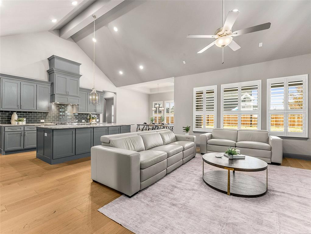 Stunning 1.5-story, 4-bedroom, 4-bath luxury home in the highly sought-after Legacy Gardens community of Prosper, Texas, set on a 0.257-acre lot. Ideally located just off the Dallas North Tollway and zoned to top-rated Prosper ISD. including the new on-site elementary school. This beautifully maintained, turnkey home feels like new construction. Inside, upgraded wide-plank wood floors flow through the main living areas. The expansive living room features soaring ceilings and a striking gas-log fireplace with a floating mantle. The gourmet kitchen showcases shaker-style cabinetry, designer subway tile, KitchenAid 6-burner cooktop, double oven, dishwasher, oversized granite island, stainless-steel apron-front sink, and a spacious walk-in pantry. A private study with French doors provides an ideal home office. The serene primary suite offers quartz-topped vanities, a soaking tub, oversized shower with bench, and a generous walk-in closet. Two additional main-floor bedrooms include walk-in closets, with one featuring its own ensuite bath. The utility room is thoughtfully designed with built-in cabinetry and a mud bench. Upstairs, enjoy a large game room connecting to a media room wired for surround sound—perfect for entertaining. A private guest suite with walk-in closet and full bath completes the second floor. Outdoor living includes an extended covered patio overlooking a spacious backyard with room for a future pool. Additional features include a 3-car garage with epoxy flooring and EV charger, custom shutters throughout, and a whole-home water softener. Residents of Legacy Gardens in Prosper enjoy exceptional amenities including an infinity-edge resort-style pool, state-of-the-art fitness studio, yoga lawn, playground, co-working lounge, and conference rooms.