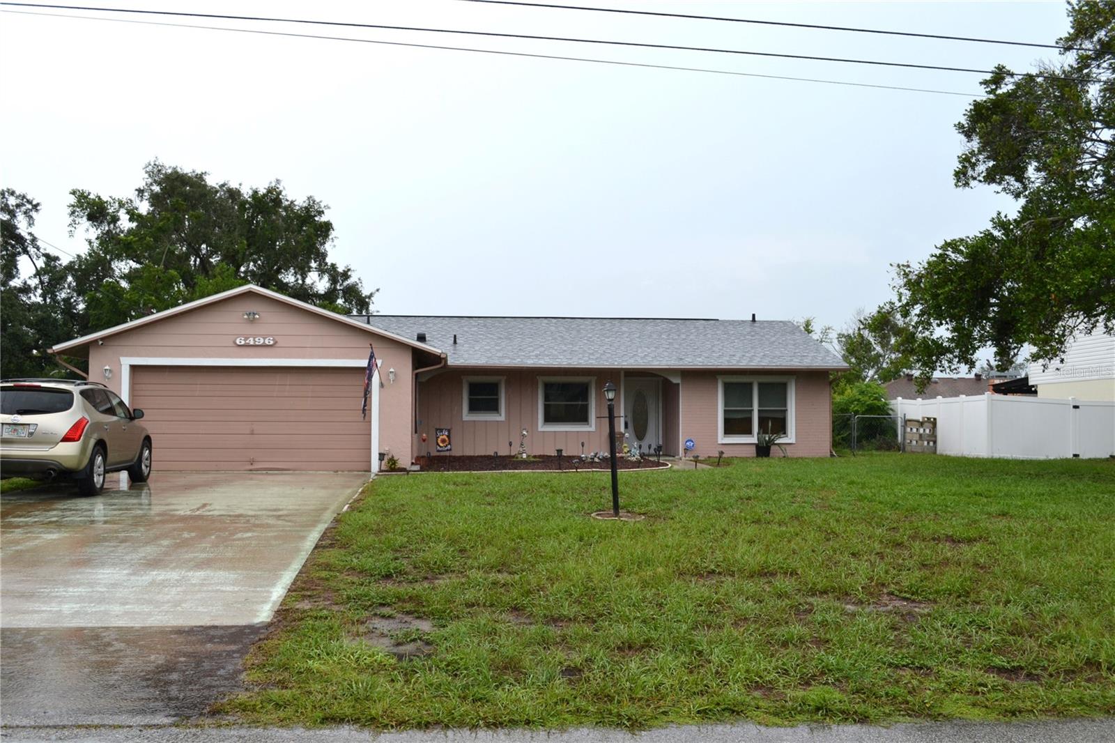 Charming 3BR/2BA pool home in the heart of Spring Hill on a lot just under a quarter acre! Enjoy Florida evenings in the fully screened-in pool with a relaxing sitting area. Peace of mind with a NEW ROOF (2024) and NEW A/C SYSTEM (2025). Updated kitchen and tile/laminate flooring throughout -- no carpet! Extra-large garage offers a dedicated workspace area, ideal for hobbies or storage. Hurricane window screens included for added protection. Fully fenced backyard for privacy and outdoor enjoyment. NO HOA! 1,264 sq ft of well-maintained living space, built in 1980. Centrally located with easy access to shopping, dining, and everyday conveniences. Don't miss this move-in ready gem!