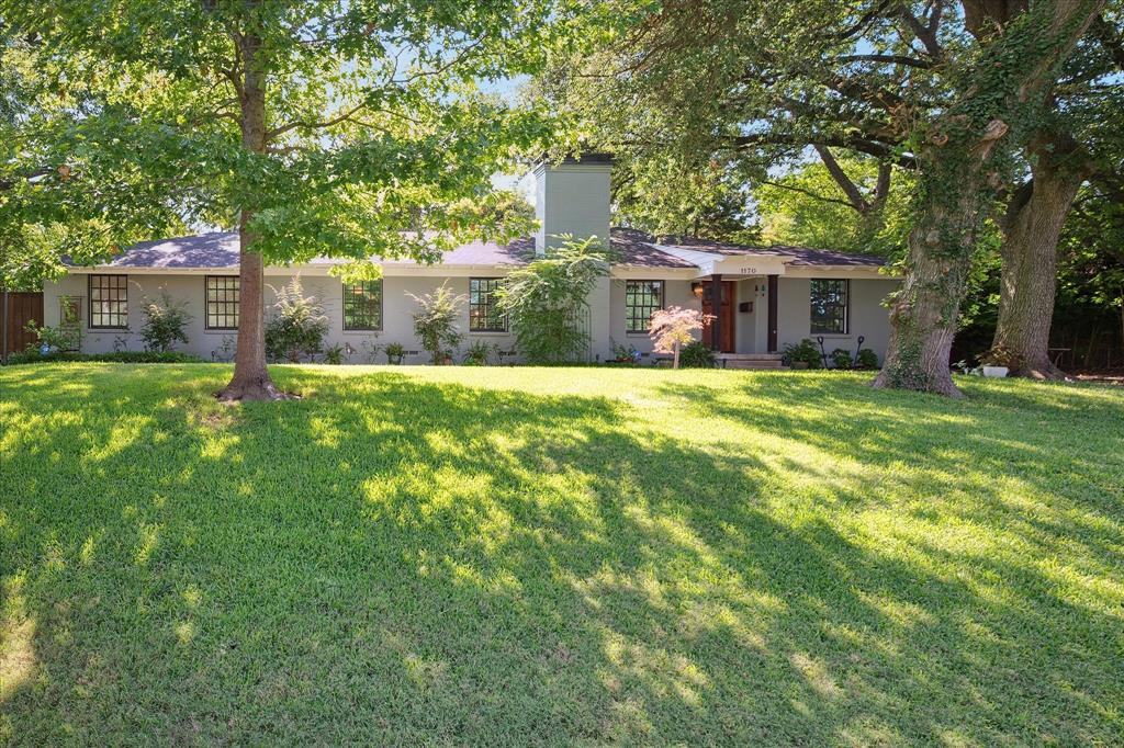 Impeccable! Welcome to this beautifully landscaped, single-story home nestled on a spacious, shaded lot adorned with large, mature trees in Lake Park Estates! From the moment you arrive, the inviting curb appeal and extended driveway set the tone for the comfort and style found inside. The owner spared no expense while upgrading the home from top to bottom, pay attention to the fine details along the way. Step into an interior through the mahogany front door that features warm original wood flooring throughout the main areas, including a formal dining room perfect for hosting gatherings. The large family room is anchored by a wood-burning fireplace, with herringbone travertine surround. The heart of the home is a spacious kitchen, thoughtfully designed with granite countertops, Bosch 5 burner gas cooktop, Bosch stainless steel appliances, and an abundance of cabinet storage— with pull out shelves and soft close drawers. Adjacent, a bright and airy sunroom offers a peaceful retreat with views of the private large backyard with an 8' board on board cedar fence, fenced in dog run, and large shed wired for electricity. Retreat to the serene split primary suite, where the fully renovated en-suite bath features dual sinks, a large walk-in shower with a luxurious rain faucet. The guest bathroom is equally impressive, offering a large soaking tub with TV connection—your guests may never want to leave! Outside, enjoy a large backyard oasis with plenty of space to entertain, a dog run for your furry friends, and a two-car garage for all your storage needs. Sellers upgraded the house with high end fixtures, solid core doors throughout, tall baseboards, craftsman style casing on all doors and windows. Double pane low-e windows, solid core interior doors, and tons of additional interior trim. Replaced sheetrock and added batt insulation between interior walls adds sound deadening and excellent temperature control! Close proximity to White Rock Lake and the Dallas Arboretum!