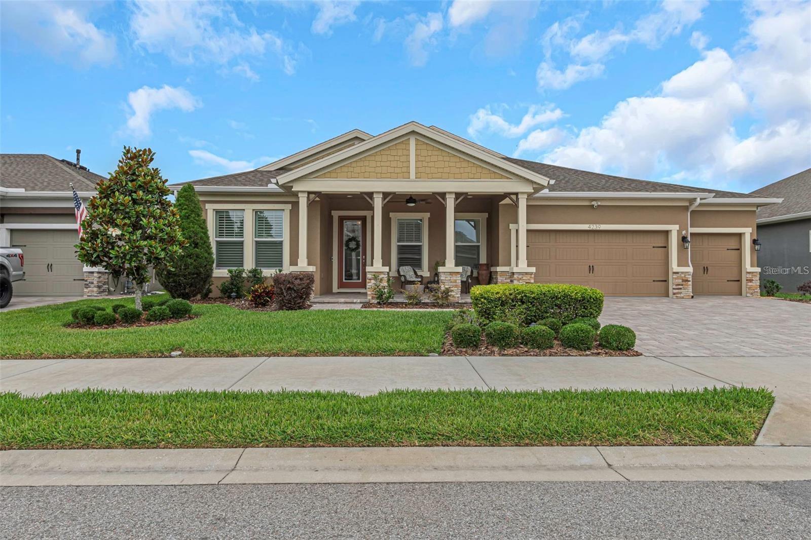 WATER VIEW LOT offering an expansive 425-ft serene view across the pond to a beautiful tree-lined conservation area within the gated community of The Woodlands at Longleaf. Built in 2021 by Homes by WestBay, this award-winning single-story home showcases exceptional natural light, thoughtful design, and over $40,000 in additional upgrades—you must see it in person to truly appreciate the quality and craftsmanship.A paver driveway leads to an oversized covered front porch, perfect for relaxing or welcoming guests. Step through the etched-glass entry and enjoy a dramatic sightline straight through the home to the stunning pond and conservation view beyond. Soaring 12-ft tray ceilings, elegant architectural details, and a 25-ft wall of sliding glass doors create a breathtaking front-to-back visual. Large windows throughout flood the home with natural light, enhancing the open-concept grand room with decorative ceiling beams and designer finishes.The gourmet kitchen features espresso cabinetry, marbled granite countertops, GE Café appliances, 5-burner gas cooktop, custom backsplash, and an oversized island ideal for gathering and entertaining. Dimmable lighting, plantation shutters, premium fixtures, and smart-home features add both comfort and sophistication.The private owner’s retreat occupies its own wing with lanai access, dual walk-in closets, and a spa-inspired bath complete with soaking tub and floor-to-ceiling tiled shower. In addition to the owner’s suite, the home offers three spacious guest bedrooms—all with walk-in closets—plus a dedicated office/den with double doors.The home is positioned and pre-wired for a future oversized pool and spa with gas and power stub-outs plus convenient pool bath access. Additional features include tankless gas water heater, whole-house water filtration and softener, full Ring security system, smart garage openers, epoxy-finished 3-car garage with overhead storage, and automated landscape lighting.Resort-style amenities include two clubhouses, two pools with spa, tennis and basketball courts, golf-cart friendly streets, scenic ponds throughout the community, and miles of paved walking and biking trails. Located within top-rated school zones and close to shopping and dining.Room sizes are approximate and should be verified by buyer. Ask for the complete detailed list of builder and post-construction upgrades.