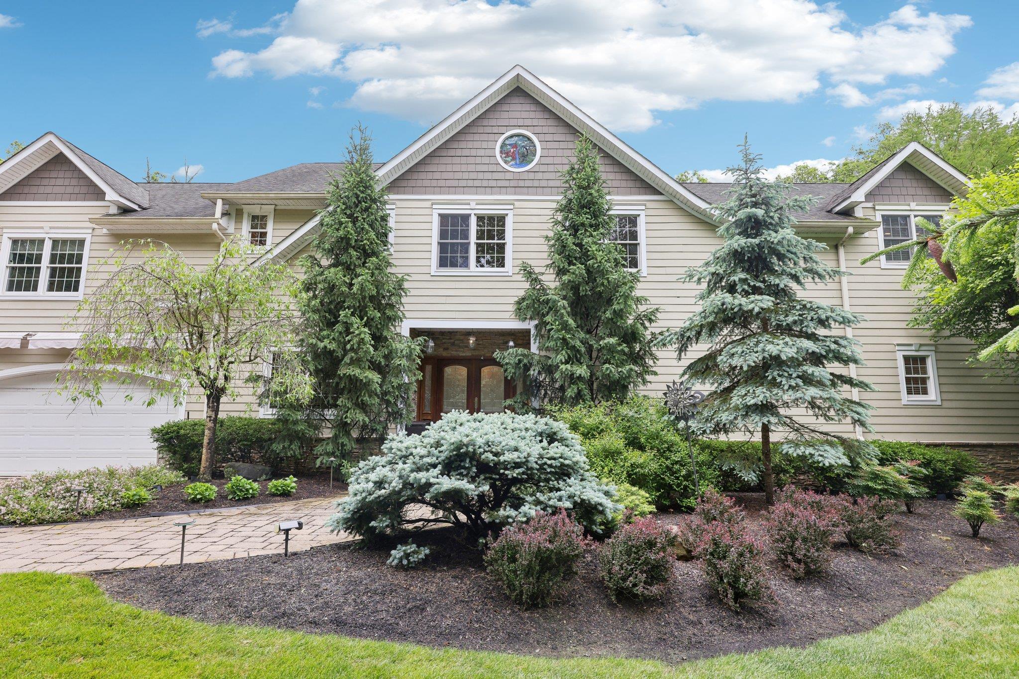 Valley Cottage, NY –Where eagles soar, tucked behind elegant stone pillars, this custom energy-efficient 5 bedroom, 3 bathroom,  4,600 sf  Colonial offers over an acre of a rare blend of privacy, nature, and luxury on the tranquil shores of Heatons Pond  where serenity surrounds you! Designed with versatility in mind, this young home features a flexible layout perfect for professionals, including a separate entrance and dedicated office space. Built beyond code with the finest materials, it boasts an easy-flow floor plan, banquet-sized rooms, and thoughtful architectural details throughout. Enjoy 9’ ceilings, gleaming hardwood floors, custom moldings, hi-hats, and a cozy fireplace, fully paid for solar system, new air conditioning and hot water tank with warranty, wiring for electric car in place. The chef’s kitchen, outfitted with granite countertops and stainless steel appliances, opens to a sprawling multi-level deck with sweeping views of the stream, specimen landscaping, and lush greenery that seems to go on forever because of a greenbelt beyond  the bridge which will remain forever natural. Retreat to your king-sized primary suite complete with a whirlpool tub, steam shower, and multi-head spray for a spa-like experience. A full, walk-out lower level awaits your personal touch—ready to be finished to suit your needs. Located just minutes from major highways, scenic Hook Mountain, and some of the best biking and nature trails in the region, in the quaint village of Nyack, this home offers the perfect balance of convenience and escape. Call for a private showing, Welcome home to the lifestyle you’ve been dreaming of!