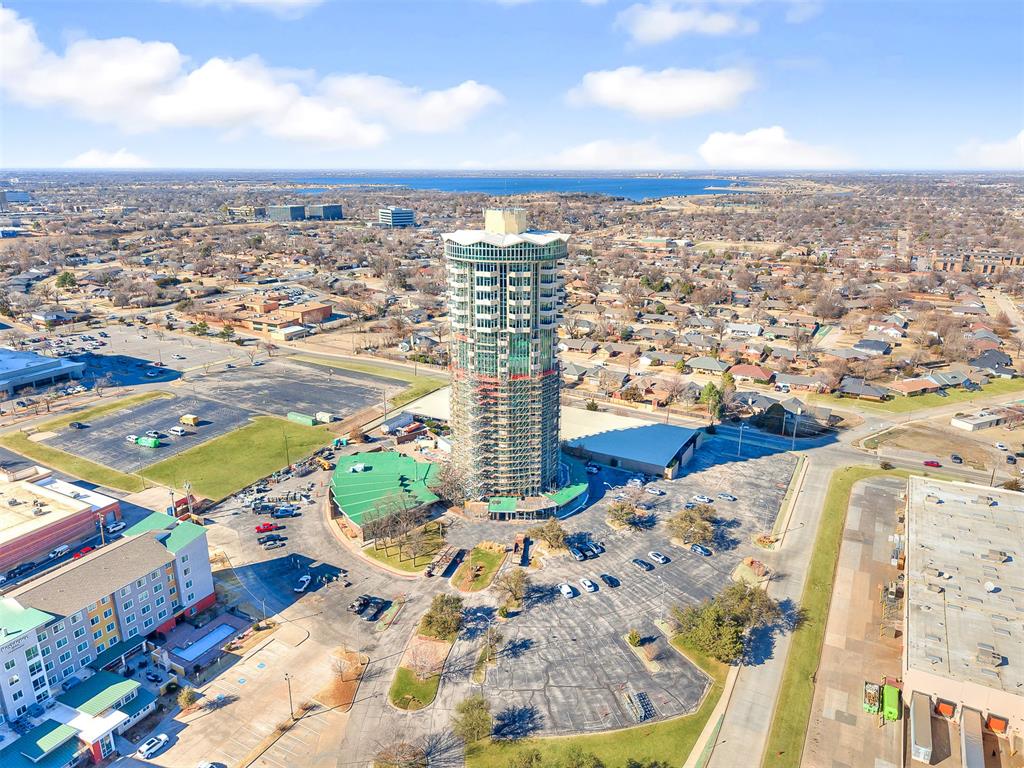 Experience elevated living on the fifth floor of the iconic Founders Tower. This 2-bedroom, 2.5-bath condominium offers a functional and spacious layout with an open living and dining area, defined kitchen space, and in-unit laundry. Floor-to-ceiling windows fill the home with natural light, while three private balconies extend from the main living area and primary suite, offering impressive exterior views.The kitchen features granite countertops, GE Profile appliances, glass-top range, stainless steel refrigerator, and sleek mid-century modern cabinetry that complements the building’s architectural character.Originally built in 1962, Founders Tower is one of Oklahoma City’s most recognizable residential landmarks. Residents enjoy true lock-and-leave living with controlled-access entry, 24-hour concierge service, on-site management, elevator access, and extensive HOA coverage including water, trash, basic cable, internet, building insurance, and common area maintenance.Community amenities include an indoor pool and spa, outdoor pool with kitchen area, fully equipped fitness center, and recreation room with lounge space, pool table, and ping pong. The detached parking garage is covered, gated, and monitored, with two reserved spaces assigned to the unit.Located along Mosteller Drive in Northwest OKC, this property offers convenient access to shopping, dining, medical facilities, and retail — with sweeping views stretching from Lake Hefner to Downtown OKC.If you’re looking for secure, low-maintenance luxury living in one of OKC’s most iconic high-rises, this is it.