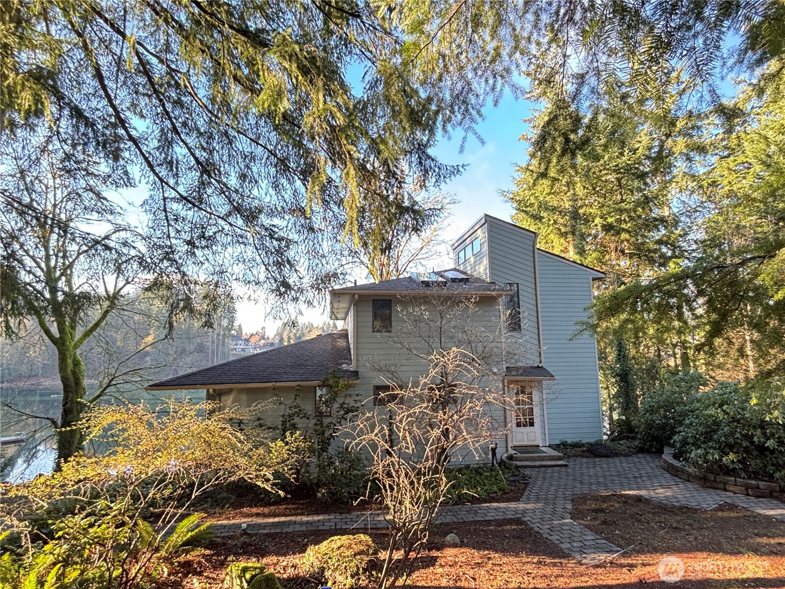 Peaceful waterfront living in an unbeatable Olympia location on Hewitt Lake. Light-filled kitchen, living, and dining rooms showcase beautiful lake views. The spacious eat-in kitchen features quartz countertops, stainless steel appliances, and maple cabinetry. Cozy living room with a freestanding pellet stove opens to a large main-level deck, perfect for entertaining. This 2,771 sq ft home offers 2 bedrooms and 3.25 baths, plus a daylight basement with a separate entrance, bonus room with closet and private deck, den/office, and half bath. Terraced backyard leads to the dock for easy lake access—ideal for kayaking, swimming, and fishing. A true waterfront retreat.