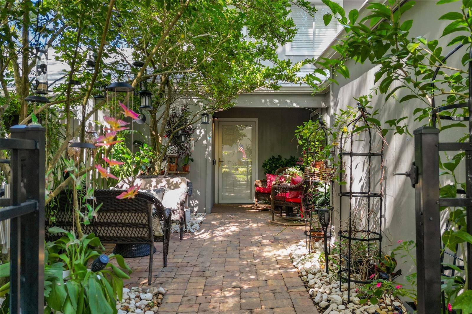 Come see this beautiful 3 bed/2½ bath move-in-ready townhouse style condo! As you enter the home through the private front courtyard, you will appreciate the new brick pavers (2023) and lovely mature trees. Once inside you will be impressed with the spacious and well-designed floor plan.  The living room is large and connects to the dining room. The kitchen which is adjacent to the dining room has plenty of cabinet space (additional cabinets added 2023), granite countertops and all stainless-steel appliances. The first floor also features a storage closet below the stairs. The back sunroom was converted to under air space and a Two-person Elevator was installed (2023). Only one in the community! Guest bathroom (updated 2023) has custom cabinets and granite countertops. Engineered Hardwood upstairs, Tile in kitchen and bathrooms and all new luxury vinyl flooring downstairs (2025). No Carpet! Fresh paint, knockdown except bedrooms #2 &  bedroom #3. Plantation shutters throughout (2023) All three bedrooms are on the second floor, very spacious with large windows for natural light and have ceiling fans in all the rooms. The Primary Bedroom features a custom closet system with solid wood dressers, shelves, and fixtures & a Primary Bath with beautiful cabinets and granite countertops (updated 2023). There is a makeup area and skylight in this bathroom as well. The guest bathroom upstairs also has custom cabinets with granite countertops (updated 2023). Located in Oak Harbour, the best kept secret in Altamonte Springs! This Gated Lakefront community offers numerous amenities such as private dock and boat ramp, gym, two swimming pools, basketball and tennis courts and a Clubhouse with Ping Pong & Pool Tables, a Library, Entertainment Area w/ Bar and a full kitchen, all available to reserve for your private party. There is a patio behind the clubhouse, equipped with Grills which is available for your use. Only minutes from Advent Health, Uptown Altamonte, Cranes Roost and the Altamonte Mall, and much, much more. Don't let this opportunity get away, come see this home before it's gone! Schedule your showing today!!