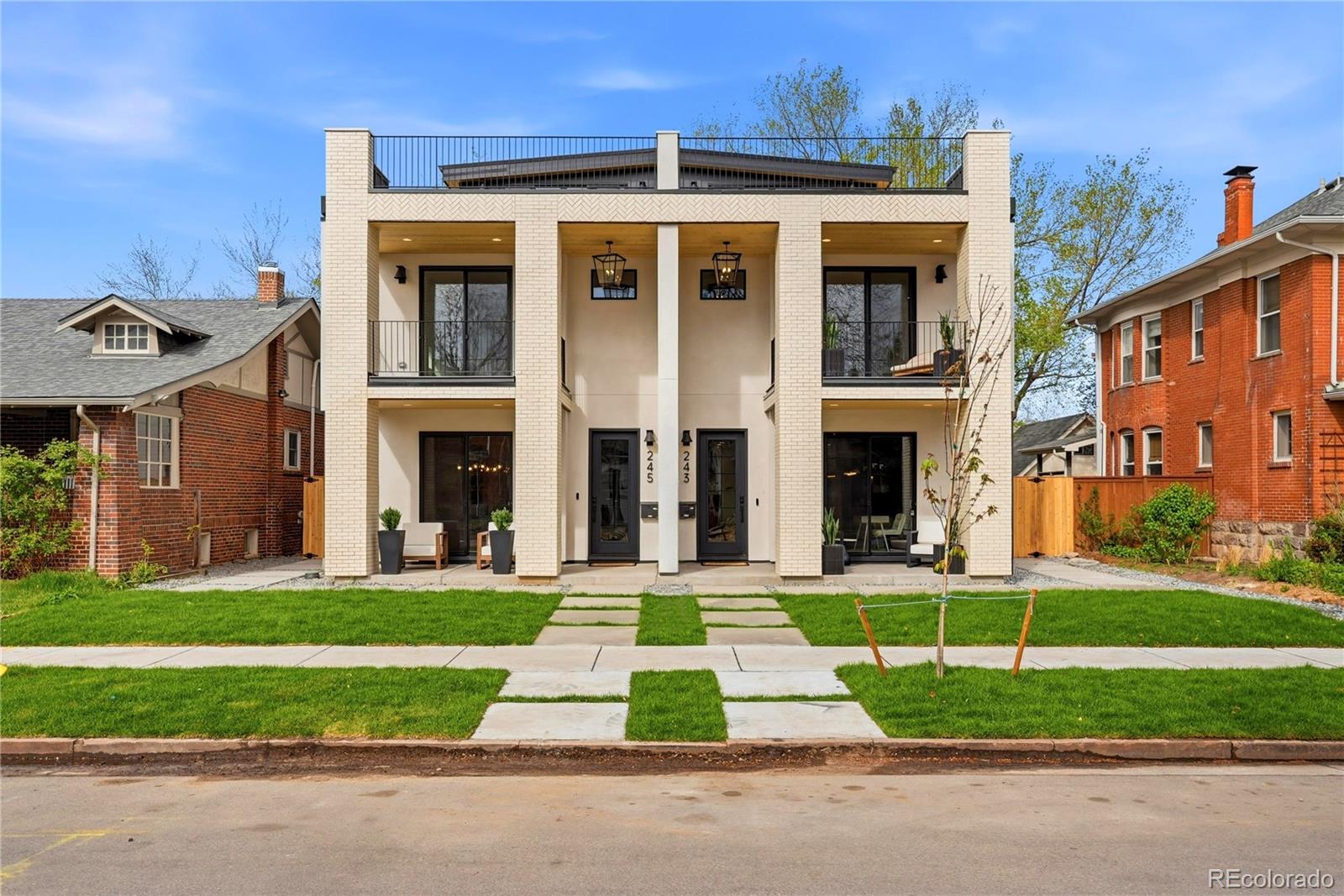 Just 3 blocks from Washington Park, this 2026 new-construction residence offers nearly 4,000 square feet with 5 bedrooms, 4.5 baths, a rare lock-off lower level with private exterior entrance, loft, rooftop deck, large yard, and an extra-height 2-car garage + 1 parking pad — an unusually complete package in Wash Park. 9.5' ceilings main level | 10' lower level | 9' primary suite.Main level delivers a wide great room with architectural fireplace, chef's kitchen with 9.5' quartz island, pot filler, professional range, paneled appliances, custom cabinetry, designer tile, and dedicated mudroom. Wide-plank hardwood throughout — including basement.Lower level is a true lock-off: private exterior entrance, 10' ceilings, wet bar, fireplace, family/theater room, ensuite bedroom with wardrobe, and dedicated laundry. Lives as a fully independent suite — ideal for multigenerational living, long-term guests, or added income flexibility.Primary retreat features private balcony, custom built-in dressing closet, and spa 5-piece bath with LED lit make up mirrors. Top-floor bedroom with panoramic views. Loft with wet bar opens to a large rooftop deck with great views — one of the finest outdoor spaces in the neighborhood. Dual HVAC | dual laundry | smart-home integration | built-in audio | security cameras | iPad control | extra-height 2-car garage | 1 parking pad | large yard. | Built to Denver Energy Code. Walk to WashPark, neighborhood shops and Broadway. 5 min to Cherry Creek.