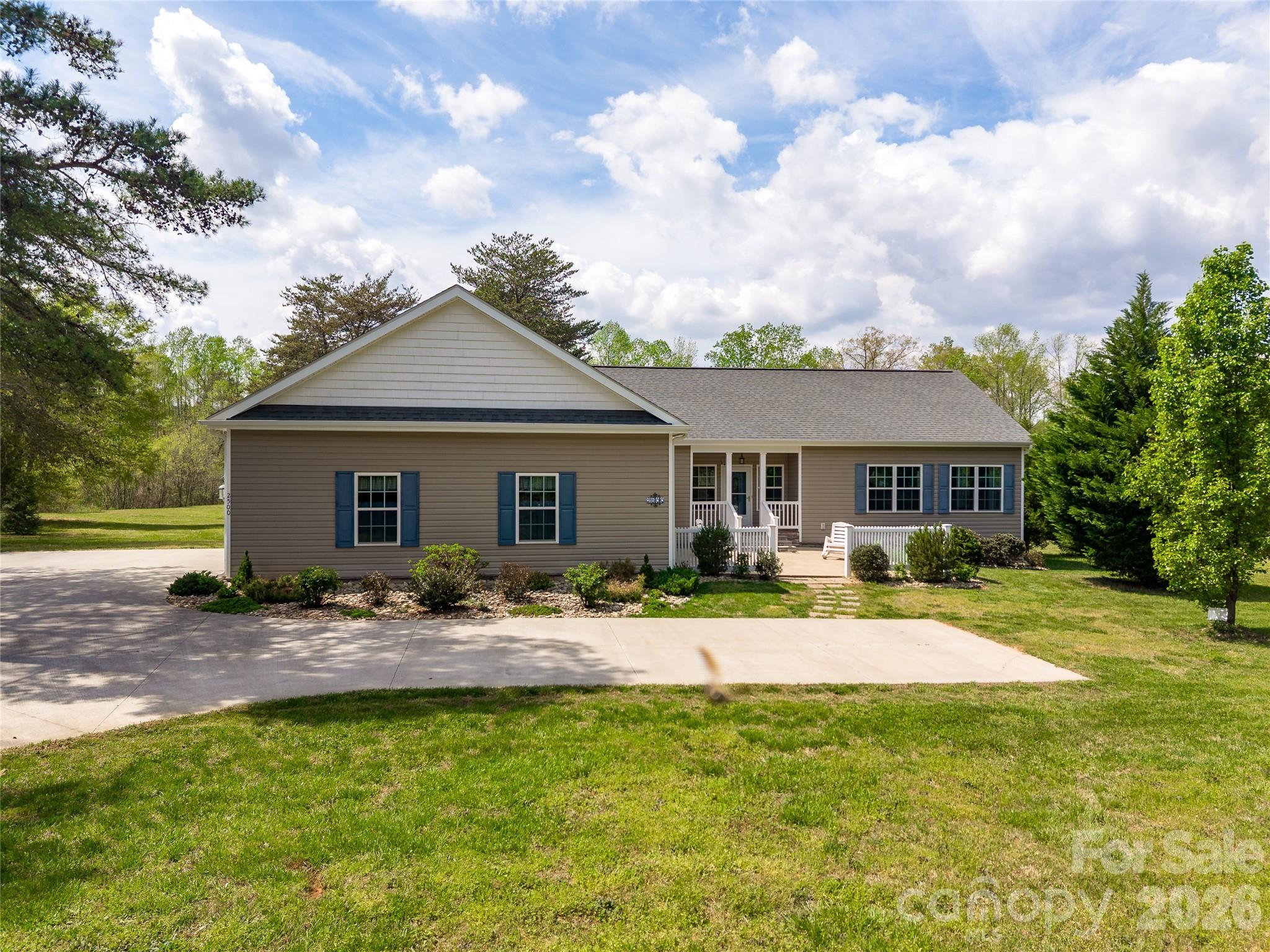 Feel right at home and create your own mini farm!!!  Country living at it's best, offering a one owner, move in ready, much loved and well kept modular construction home with two stick built additions including the sunroom and spacious extended two car garage. The floorplan was designed with future handicap accessibility in mind. Other features of the home include spacious rooms with 9' ceilings, engineered hardwood flooring throughout, an attractive gas log fireplace and built ins in the living room, an open kitchen area with granite counter tops, mostly newer appliances and a built in breakfast nook.  Oversized bathrooms with luxury vinyl floors. A fabulous sunroom that opens to the pergola covered deck and a separate balcony exclusive to the Bull Frog hot tub that seats up to 6.  Low maintenance exterior, two hot water heaters, an encapsulated crawl space with dehumidifier and so much more! Matching the home is also an additional site built 24 X 24 two car garage that was added in 2020 that has enforced concrete for a lift and is wired for 220 plus a 30 X 16 steel and aluminum camper-port that is perfect for a motor home or horse trailer and also can fit two vehicles in tandem!  Extensive concrete driveway,  with an additional parking pad for two vehicles and stamped concrete front patio. This is a great opportunity, don't miss out!