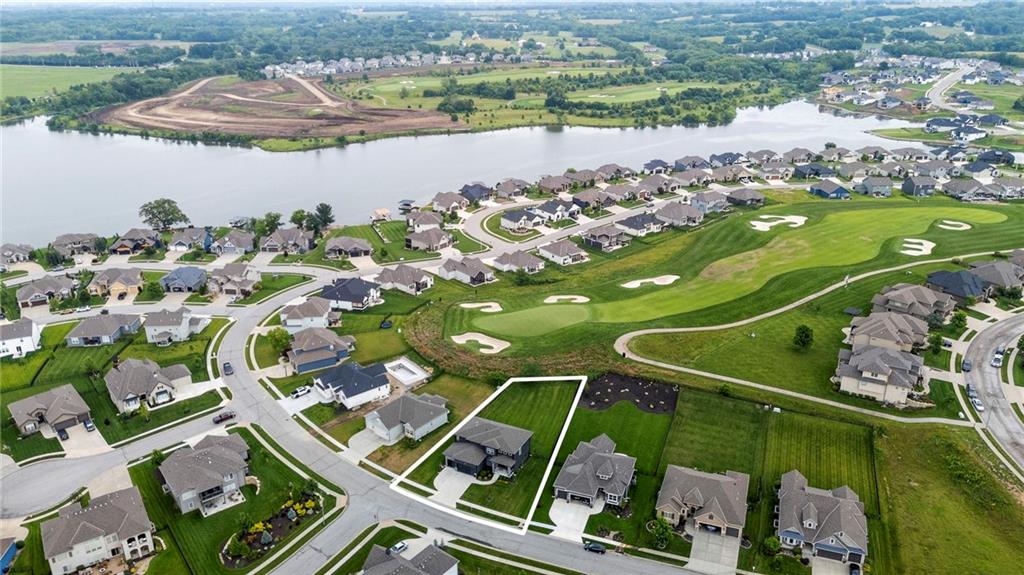 Showstopper in Edgewater at Creekmoor – Backing to the 16th Hole with Over 4,800 Finished Sq Ft! Welcome to resort-style living in this stunning 6-bedroom, 5-bathroom home perfectly positioned along the 16th fairway of Creekmoor’s premier golf course! This thoughtfully designed home offers the perfect blend of elegance, comfort, and endless recreation. Gorgeous wood floors flow throughout the open main level, leading to a light-filled great room with cozy fireplace and custom built-ins. The chef’s kitchen is a true standout—quartz countertops, large center island, stainless steel appliances, abundant cabinetry, walk-in pantry, and a convenient drop zone to keep life organized. Front flex room adds versatility for formal dining or additional living space. Main level also includes a bedroom and full bath—perfect for guests or a home office. Upstairs, the spacious primary retreat is a dream with its own sitting area, fireplace, spa-like en-suite featuring dual vanities, soaking tub, walk-in shower, and two walk-in closets. Bedroom-level laundry room connects directly to the primary closet for unmatched convenience. Bedrooms 3 and 4 share a bath between them, while Bedroom 5 enjoys a private en-suite. Finished basement is ready for entertaining with a huge family room, wet bar, rec room, sixth bedroom, and fifth full bath. Step outside to the covered patio, perfect for relaxing evenings and morning coffee. The fully fenced backyard includes oversized gates, providing easy access for equipment or added functionality. Creekmoor amenities are second to none—championship golf, pro shop and clubhouse, 24-hour fitness center with locker rooms, three pools, tennis and pickleball courts, two pavilions for events, a boating marina, miles of walking trails, and a stocked 108-acre lake for swimming, sailing, paddleboarding, and fishing. This is more than a home—it’s a lifestyle. Welcome to your dream home in Creekmoor!