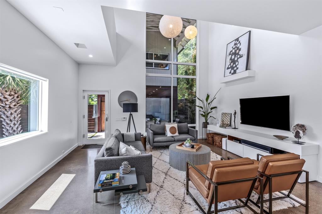 Urban contemporary masterpiece just steps from Henderson’s most coveted dining, nightlife, and shopping hot spots! This architecturally significant, one-of-a-kind residence is a true showstopper, designed for the discerning modern buyer who values clean lines, natural light, and intentional design. Originally custom built by its first owners—professionals in architecture and design inspired by their time in Japan—this home is the perfect blend of form and function. The open-concept layout features walls of glass that flood the interiors with natural light—ideal for art lovers—along with polished concrete floors, museum-finish walls, and luxurious Ann Sacks tile throughout. The chef’s kitchen is the heart of the home, boasting an expansive island perfect for meal prep, casual dining, or gathering with guests. Outfitted with high-end appliances and custom cabinetry, it opens via expansive panoramic doors directly to the heated pool and outdoor living area, creating an effortless indoor-outdoor connection. Perfect for entertaining and unforgettable dinner parties, the backyard is a private oasis featuring a gorgeous pool, lush professional landscaping, and low-maintenance turf. Multiple zones for lounging, dining, and relaxing make this space as functional as it is beautiful. The primary bedroom and bathroom provide a true escape, offering a serene and luxurious retreat from everyday life. A second living area offers flexible space ideal as a study, TV room, lounge, or additional entertaining area, providing excellent versatility for daily living or hosting guests. An oversized garage provides ample room for parking, storage, or a workshop—rare for the area. A rare and refined offering in an unbeatable location—this home is truly one of a kind and an absolute must-see.