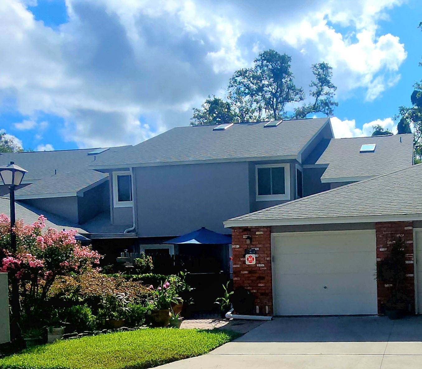 Welcome to the charming, gated community of Oak Harbour!  This Highly sought after 3 bedroom, 2.5 bath, MAIN FLOOR MASTER BEDROOM condo is awaiting you!!  It offers an open floor plan with spacious living area and an additional flex space for office, den, workout room or art studio. Amazing high soaring ceilings.  New 2022 roof and exterior paint.  A private attached single car garage.  Some of the amazing upgrades include beautiful cabinetry and state-of-the-art quartz countertops.  New stainless-steel kitchen sink and faucet. New thermal windows with professionally installed window coverings. Continuous high-grade luxury flooring throughout. Upgraded electrical box, new lighting in all baths, and new Hunter ceiling fans throughout. Brand new enclosed porch with windows, door to back patio and security light. You can take an easy stroll down the Oak canopied streets to the Lake and walk out to the beautiful, covered dock.  Perfect place for watching the Cranes Roost 4th of July fireworks over Lake Orienta or the beautiful nightly sunsets. Within the community you will find the newly renovated club house, fitness center and sauna.  In addition, there are many other amenities at your fingertips.  You have access to two beautiful community pool areas, tennis courts, pickle ball, shuffleboard, monthly activities, club house with outdoor grilling area, lake access, gated community, and a short distance away from Uptown Altamonte and downtown Maitland.  There is nearby shopping, restaurants, churches, hospitals, and close proximity to the beaches. A perfect place to call home. This is 100% move in ready and a must see!