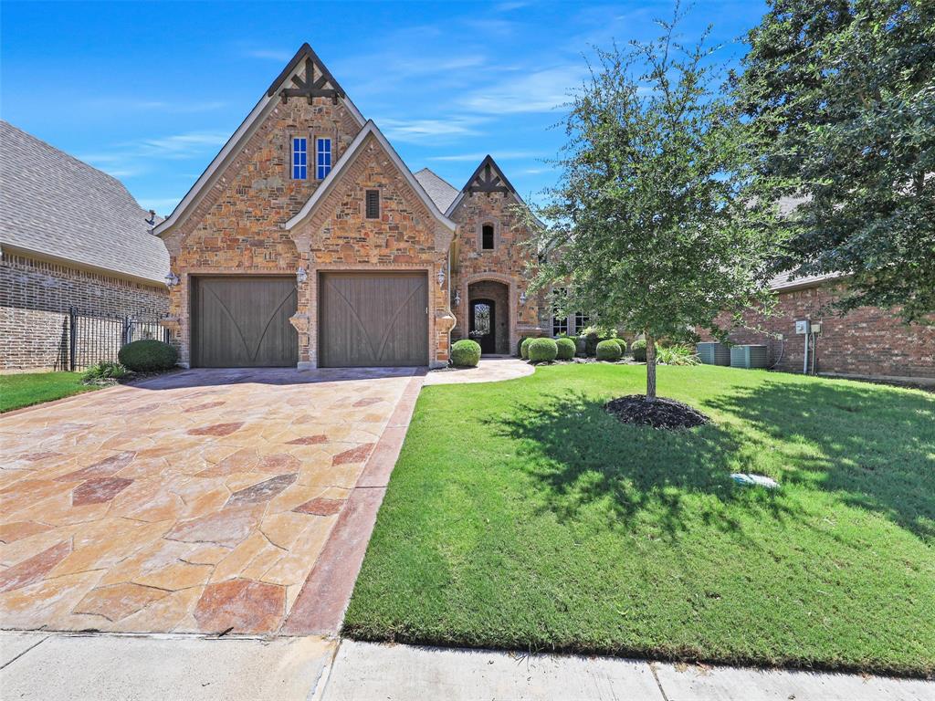MAIN HVAC HAS BEEN REPLACED! This stunning and timeless custom home in the gated Villas of Colleyville offers a fabulous floorplan with spacious rooms, including a freshly painted downstairs media room, an appointed office with built-in bookcase, mud area, exquisite millwork, and a fabulous outdoor living area. The kitchen is a chef’s dream with custom wood cabinetry and a large island open to the main living area, which features soaring ceilings and a striking stone fireplace—creating the perfect space for entertaining. The spacious primary suite includes a jetted tub, separate shower, dual vanities, and a large walk-in closet. Upstairs, you’ll find two additional bedrooms, including one with an en suite bath, a workstation, plus a bonus room that could easily function as a fourth bedroom or game room. Step outside to enjoy the private outdoor living with a large covered patio featuring a fireplace and built-in grill—ideal for year-round relaxation. The back fence has been recently stained. A three-car tandem garage offers flexible space, with the tandem bay easily convertible into an additional bedroom or hobby room. Set on a private lot, this property provides a peaceful setting with plenty of space and privacy—truly lovely in every way.