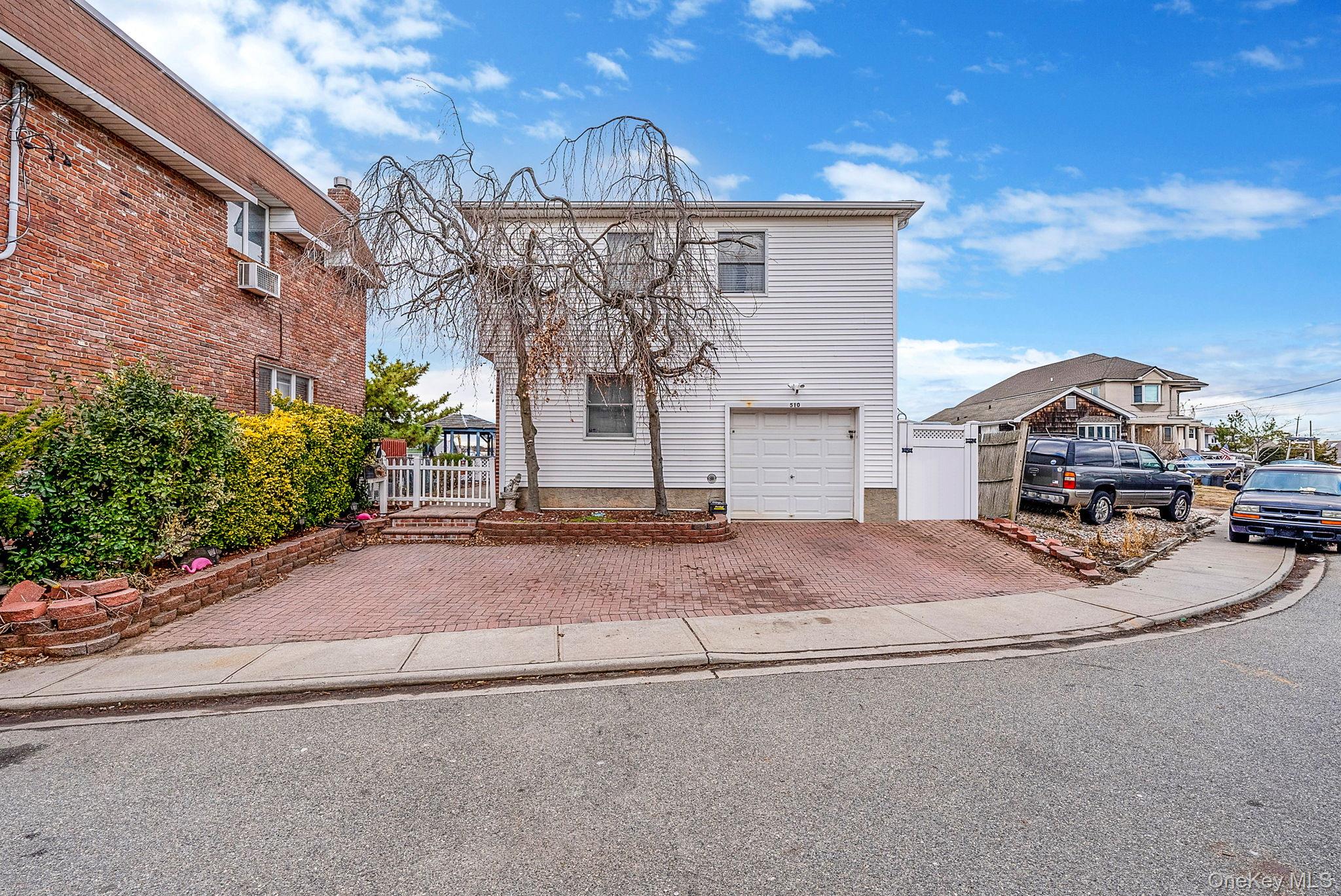 Step into the welcoming entry foyer of this 5-bedroom, 3-bath Hi-Ranch with approximately 2,100 square feet and serene canal views. The upper level is the heart of the home, featuring hardwood floors, a spacious living and dining room combination with fireplace, and an updated kitchen with granite countertops. The upper level also includes the primary bedroom with private en-suite and two additional bedrooms and a full bathroom. Sliding glass doors open to a deck overlooking the canal—perfect for relaxing or entertaining.The lower level offers two bedrooms, a full bathroom, bonus room and a laundry area, ideal for guests, work-from-home space, or flexible living. 1 car attached garage, a fully fenced yard, patio, and dock space all combining to create a comfortable home with a versatile layout and peaceful waterfront setting. ASK AGENT ABOUT POSSIBLE RENOVATIONS