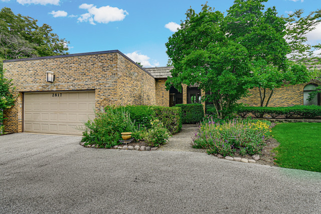 An extraordinary opportunity to own this spectacular one-of-a-kind custom contemporary brick bi-level home offering over 3,000 square feet of exceptional living space, perfectly positioned on a breathtaking golf course setting. Designed for those who appreciate distinctive architecture and remarkable entertaining spaces, this 4-bedroom, 2.5-bath residence is unlike anything else on the market. A beautifully landscaped courtyard welcomes you with colorful flowers, lush greenery, and a peaceful sitting area that creates a warm and inviting first impression. Inside, the impressive foyer with custom ceramic floors opens to a thoughtfully designed floor plan that combines elegance, comfort, and functionality. The dramatic living and dining rooms are truly the centerpiece of the home, featuring soaring floor-to-ceiling windows that frame spectacular golf course views while filling the home with natural light. A striking wood-burning fireplace set against a beautiful brick wall creates the perfect gathering space for family and friends. The oversized kitchen is every cook's dream, offering granite countertops, abundant cabinetry, recessed lighting, breakfast bar, generous table space, and all appliances included. Sliding doors open to an impressive 60-foot covered balcony extending across the back of the home, providing seamless indoor-outdoor living and incredible views of the professionally landscaped backyard and the golf course. The spacious primary suite is a private retreat featuring floor-to-ceiling windows, balcony access, a dressing area, mirrored closets, a double vanity, and a luxurious sunken whirlpool tub with a separate shower. The second bedroom also features floor-to-ceiling windows with access to the charming front courtyard. A second full bath includes another relaxing sunken whirlpool tub, adding comfort and style for family or guests. The expansive walkout lower level offers endless possibilities with a huge family room highlighted by a second wood-burning fireplace, floor-to-ceiling windows, patio doors leading to a beautiful brick paver patio, a wine cellar, an additional versatile room perfect for a fourth bedroom, home office, fitness room, or den. Step outside to enjoy the fenced backyard with beautifully landscaped walkways, mature greenery, and direct golf course views that provide a peaceful and picturesque setting year-round. Additional highlights include a brand-new furnace and brand-new central air conditioner with four zoned system, four year roof, main-floor laundry with pantry/storage area, security system, attached two-car garage, and exceptional closet and storage space throughout. Homes of this caliber, with this architectural character, over 3,000 square feet of living space, and an unmatched golf course location, rarely become available. This is more than a home-it's a lifestyle. Schedule your private showing today before this remarkable property is gone!