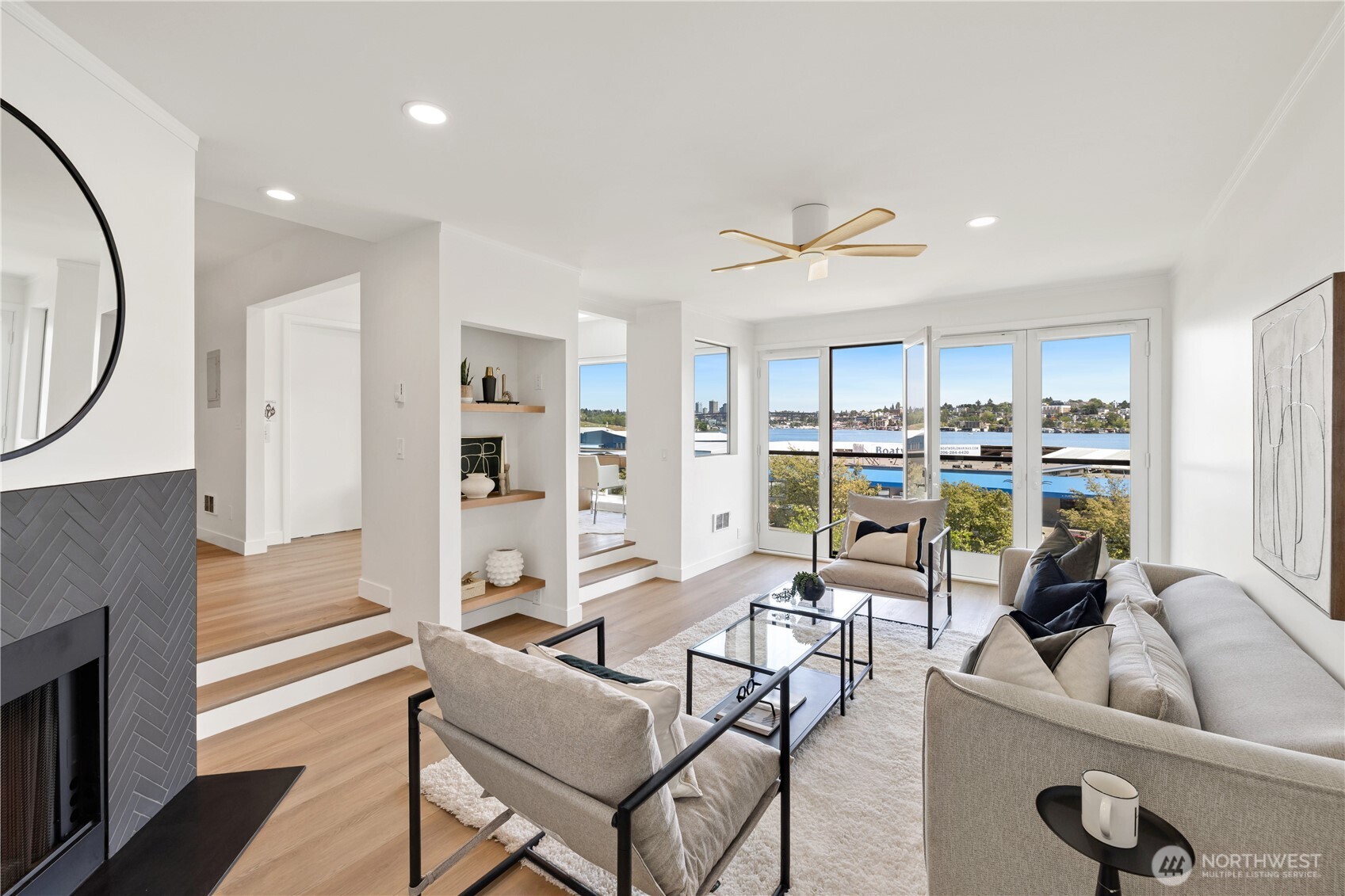 Experience waterfront living at its finest in this beautifully updated 2-bedroom, 2-bath condo on the shores of Lake Union. Located in a secure boutique building, this light-filled home offers walls of windows and two sets of French doors that frame ever-changing lake views filled with sailboats, seaplanes, and stunning sunsets. Enjoy an unbeatable vantage point for Fourth of July fireworks right from home. Thoughtfully updated with new flooring, fresh paint, a remodeled kitchen, and renovated bathrooms for a true turnkey feel. Private keyed elevator access provides comfort and security, while amenities include secure parking, guest parking, storage, and a fitness room. Just moments from Amazon, South Lake Union, top dining, waterfront parks, coffee shops, and the vibrant energy that makes this one of Seattle's most iconic waterfront neighborhoods. City living and peaceful lakeside living beautifully combined.