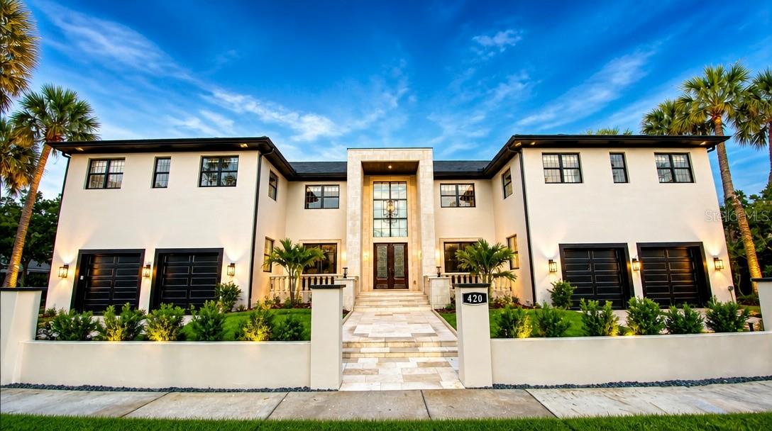 One or more photo(s) has been virtually staged. Nestled in one of Tampa's most prestigious neighborhoods, 420 S Royal Poinciana is a stunning masterpiece that embodies luxury and sophisticated living. This exquisite property transcends the ordinary, featuring a blend of modern amenities and timeless elegance. With its prime location, this residence offers an extraordinary lifestyle for discerning buyers.Approaching the home, you are greeted by a beautifully landscaped front yard, showcasing manicured gardens with tropical plants, lush palm trees, and flowering shrubs. The elegant façade boasts a combination of natural stone and stucco, complemented by oversized windows that invite natural light into the interiors. A grand entrance with an impressive double door leads into the home.The outdoor living space is equally breathtaking, with an impeccably landscaped backyard. The outdoor area is designed for both entertaining and relaxation.As you step inside, the grandeur of the home is immediately evident. The foyer boasts soaring ceilings and a large chandelier, setting the tone for the luxurious atmosphere found throughout the property. High-end finishes, including marble and hardwood flooring, crown molding, and designer fixtures, enhance the sophisticated appeal of the home's interior.The spacious family room features a fireplace and panoramic windows that provide sweeping views of the outdoor retreat. Adjacent to the living area, the formal dining room is ideal for hosting dinner parties.The gourmet kitchen is a chef's dream, equipped with state-of-the-art appliances, including a commercial-grade refrigerator, double ovens, and a six-burner gas range. An expansive center island with a breakfast bar invites casual dining, while the custom cabinetry and elegant backsplash add a touch of luxury. The space also includes a separate butler's pantry, enhancing the functionality of the kitchen.The home offers multiple spacious bedrooms, each of the 5 bedrooms upstairs with en-suite bathrooms and spacious closets, designed with high ceilings and large windows that bring the beauty if the outdoors inside.. The master suite serves as a private sanctuary, featuring a sitting area, luxurious spa-like bathroom with a soaking tub and a walk-in shower, and direct access to a private terrace overlooking the back yard retreat. The Bedroom downstairs has the full bathroom just outside the double door entry. The property includes a dedicated office, a Climate controlled room perfect for Wine/Cigar/Purse/Shoe room.  A four-car garage provides ample space for vehicles and storage. Located in Tampa's desirable South Tampa area, 420 S Royal Poinciana offers proximity to upscale dining, retail shops, and cultural attractions. The neighborhood is known for its vibrant community.420 S Royal Poinciana is not just a home; it is a lifestyle. With its  prime location, this property represents the pinnacle of high-end living in Tampa, FL. Whether entertaining guests or enjoying quiet family gatherings, this residence promises an extraordinary experience for its future owners.