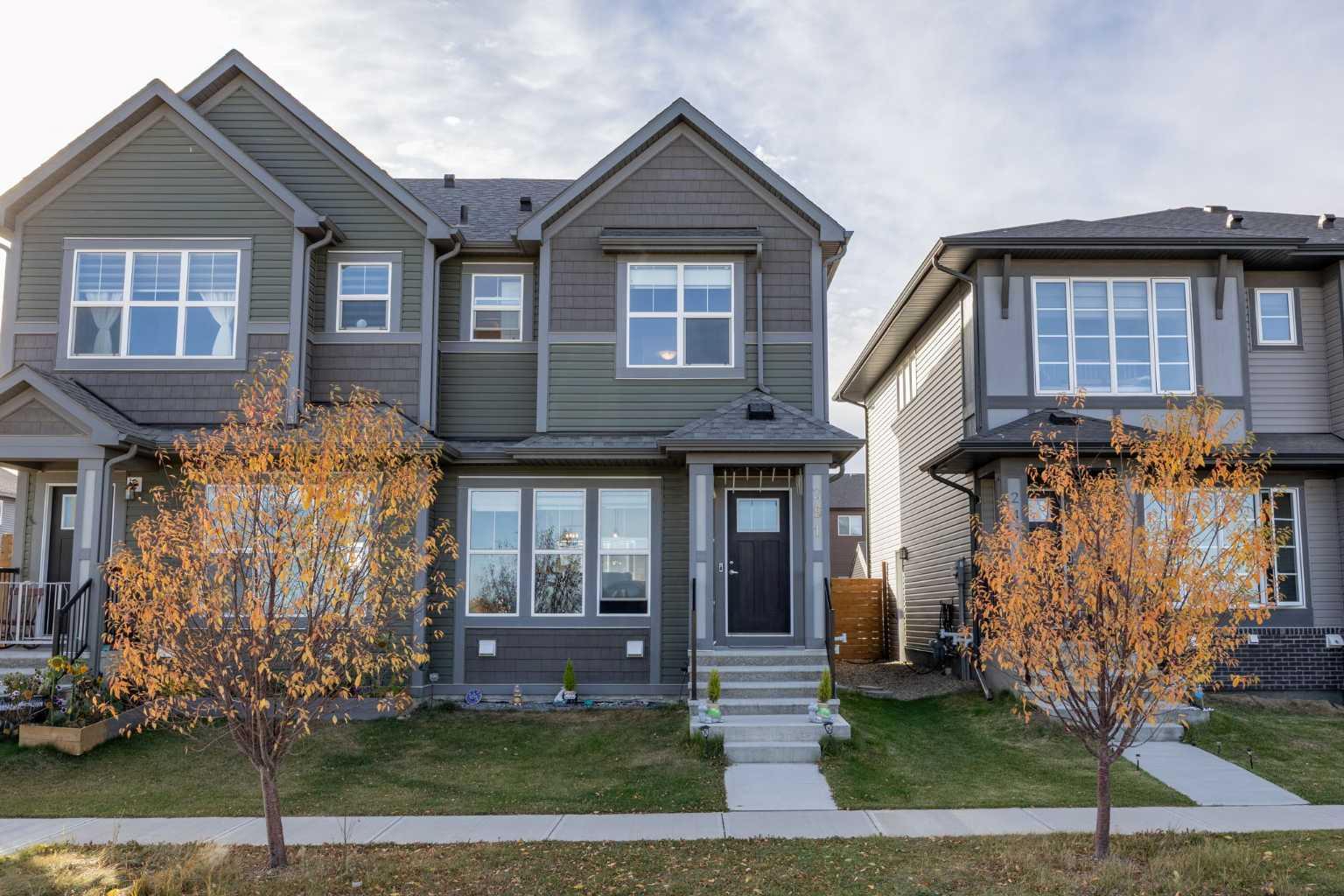 Welcome to this beautifully maintained duplex in the highly desirable community of Chinook Gate, offering a fully developed basement, a detached double garage, and a sunny west-facing backyard. Step inside and discover a bright, open-concept main floor designed for both everyday living and entertaining. The spacious living room flows seamlessly into the dining area and modern kitchen, creating an inviting atmosphere filled with natural light. The kitchen features ample cabinetry, a convenient walk-in pantry, and easy access to the rear deck, perfect for summer barbecues and outdoor gatherings. A 2-piece powder room completes the main level. Upstairs, you'll find three comfortable bedrooms, including a spacious primary retreat complete with a walk-in closet and a private ensuite bathroom. A bonus is the beautiful view from the primary bedroom overlooking a tranquil green space, creating a peaceful setting to start and end your day. Two additional bedrooms, a full bathroom, and the convenience of upper-floor laundry make this level ideal for families. The fully finished basement adds valuable living space with a large recreation room, an additional bedroom, and a full bathroom, making it perfect for guests, teenagers, or a home office setup. Outside, enjoy the west-facing backyard where you can soak up the afternoon and evening sun. The deck provides an excellent space for relaxing and entertaining, while the detached double garage offers secure parking and additional storage. Located in the vibrant and family-friendly community of Chinook Gate, this home is just steps from pathways, playgrounds, schools, and the spectacular Chinook Winds Regional Park, one of Airdrie's premier recreational destinations featuring sports fields, splash parks, skate parks, walking paths, and year-round community activities. You'll also appreciate the convenient access to shopping, restaurants, public transit, and major roadways for an easy commute. This move-in-ready home offers the perfect combination of comfort, functionality, and location. Don't miss your opportunity to make it yours!