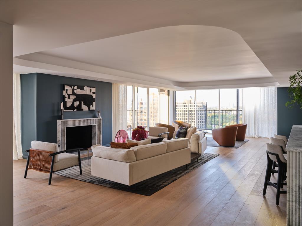 Completed in September 2026, this corner penthouse is entirely new, with interior design and architecture by Fairmount Design Studio and construction by Kitchen Design Concepts. Custom luxury finishes are featured throughout the residence. Floor-to-ceiling double-pane windows provide abundant natural light, while the wraparound terrace extends the living experience outdoors for morning coffee or sunset gatherings above the lush greenery of Turtle Creek.The open-concept floor plan is centered around a spacious kitchen with luxurious finishes and generous island seating. A dramatic fireplace, sculptural wine display, and elegant bar create distinctive focal points for effortless entertaining. The primary suite offers an intimate retreat with hotel-inspired details, including custom millwork, mood lighting, and an elegant bath with thoughtfully curated finishes. Spacious secondary bedrooms, abundant storage, and all-new systems reflect the quality and attention to detail found throughout. Two reserved parking spaces, a dedicated storage unit, and thoughtful building amenities complete this turnkey opportunity in one of Dallas’ most desirable settings.