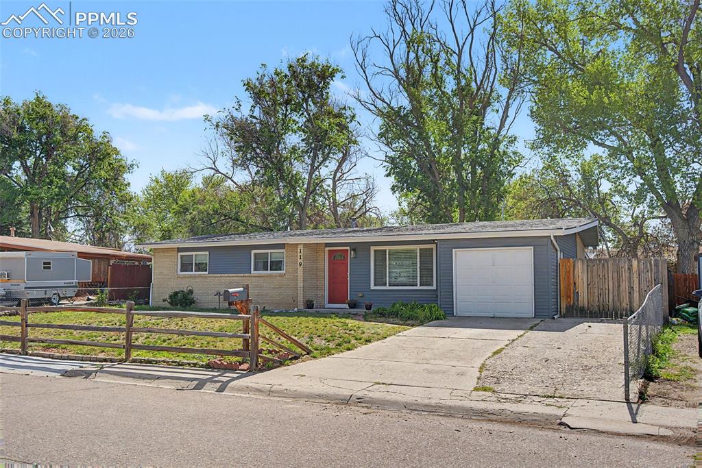 Set on a spacious lot in an established neighborhood, this ranch-style property offers a comfortable, functional layout with generous living space and thoughtful updates. Warm wood flooring carries through much of the main living area, while large windows bring in abundant natural light and create an open, welcoming feel throughout the home. The living room flows easily into the dining area and kitchen, creating connected yet defined spaces for both everyday living and entertaining. The kitchen features full-height cabinetry, tile backsplash, stainless steel appliances, and walk-out access to the covered back patio and yard. Just off the kitchen, the oversized walk-in laundry room offers exceptional storage with built-in cabinetry that functions perfectly as additional pantry space, linen storage or everyday organization, along with convenient access to the attached garage. The main level includes three bedrooms and two bathrooms, including a private primary suite with its own attached 3/4 bath with walk-in shower. A large full bathroom serves the additional main-level bedrooms. Downstairs, the fully finished basement expands the living space substantially with a large family room with vinyl-plank flooring, two additional bedrooms, another full bathroom, an enormous, finished storage closet and a large mechanical room. Outside, the property continues to impress with a large, fenced backyard, mature trees, storage shed and an expansive covered patio ideal for relaxing, entertaining or enjoying Colorado evenings outdoors. The front yard offers great curb appeal with established landscaping and additional usable outdoor space, as well as expanded driveway parking. Conveniently located near parks, shopping, dining and everyday amenities, the home also offers quick access to Fort Carson, Powers Boulevard and I-25 for an easy commute around Colorado Springs. Widefield Elementary is just a short walk away, adding even more convenience to this well-located property.