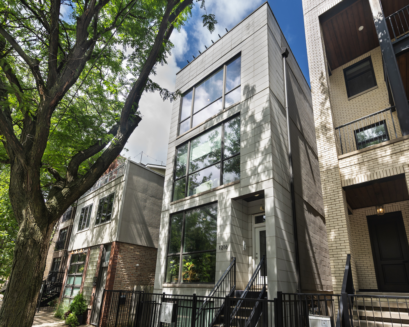 Sophisticated and Modern 2-bedroom, 2-bathroom residence with a PRIVATE rooftop deck, perfectly nestled on a picturesque, tree-lined street in the highly sought-after Fulton Market/West Town neighborhood.  Soaring ceilings and expansive windows flood the space with natural light, accentuating the home's bright, airy ambiance. The sleek, modern kitchen is a chef's dream, featuring quartz countertops, premium Bosch and Thermador appliances, and a striking counter-to-ceiling backsplash. The spacious primary suite boasts a walk-in closet with custom built-ins, while the luxurious, spa-inspired bath includes heated floors, dual vanities, a separate soaking tub, and a steam shower for the ultimate in relaxation. 2nd bedroom is a generous size w/ additional shelving, built-out closet, and built-in Murphy bed. Beautiful oak flooring runs throughout, complemented by a built-in audio system for seamless entertaining. An interior staircase leads to an upper-level wet bar with a refrigerator, opening to your expansive private rooftop oasis - spanning the entire footprint of the unit - and offering panoramic skyline views, perfect for unforgettable gatherings. Truly an entertainer's dream with a low monthly HOA. One garage parking space with additional storage racks is included in the price. All this and an incredible location with easy access to Fulton Market, West Loop, Ukraine Village, River West, Grand Blueline station, Hwy 90/94 as well as countless restaurants and shops!
