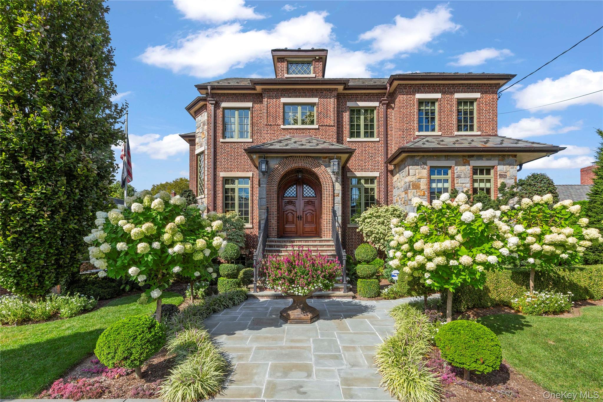 A Modern Masterpiece in the Heart of Beechhurst

Step into this exceptional four-bedroom, four-and-a-half-bathroom, 4,100 sq. ft. residence on an expansive 80x100 lot, where luxury, technology, and timeless craftsmanship come together in perfect harmony.

The first floor is filled with natural light and designed for both comfort and entertaining. It features a private office, a gourmet chef’s kitchen with Wolf appliances, a formal dining room, and a spacious family room, all seamlessly connected to create an open, flowing layout.

Upstairs, the second-floor master suite is a true retreat, boasting a spa-inspired marble bathroom with a soaking tub. Three additional bedrooms complete the level: one with a private ensuite and two sharing a Jack-and-Jill bathroom, ideal for family living. Laundry rooms are conveniently located on both the second floor and basement.

The basement offers a versatile living space with a large living room, a maple temperature-controlled wine cellar with full sink, and a custom deli station designed for wine and cheese tastings—perfect for entertaining or relaxing in style.

Additional features include a two-car heated garage with a heated driveway, and throughout the home, radiant heating, Sonos multi-zone speakers, Lutron lighting, automatic shades, a smart-home system, and a full video security setup ensure modern convenience at every turn.

Step outside to the ultimate backyard oasis, featuring a heated saltwater pool with an attached jacuzzi and a fully equipped outdoor kitchen complete with a pizza oven, ideal for entertaining on any scale.

From its sophisticated finishes to its innovative amenities, this Beechhurst residence represents the pinnacle of modern luxury living. Featured Residential Sales.